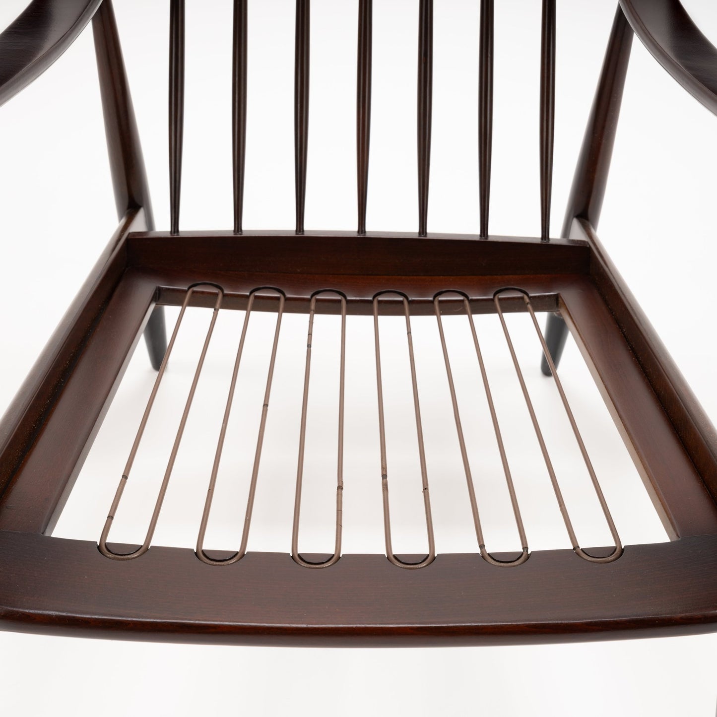 Peter Hvidt Model FD 145 Lounge Chair underside showing dark wood frame exposed metal seat springs and vertical back spindles in vintage Danish furniture style