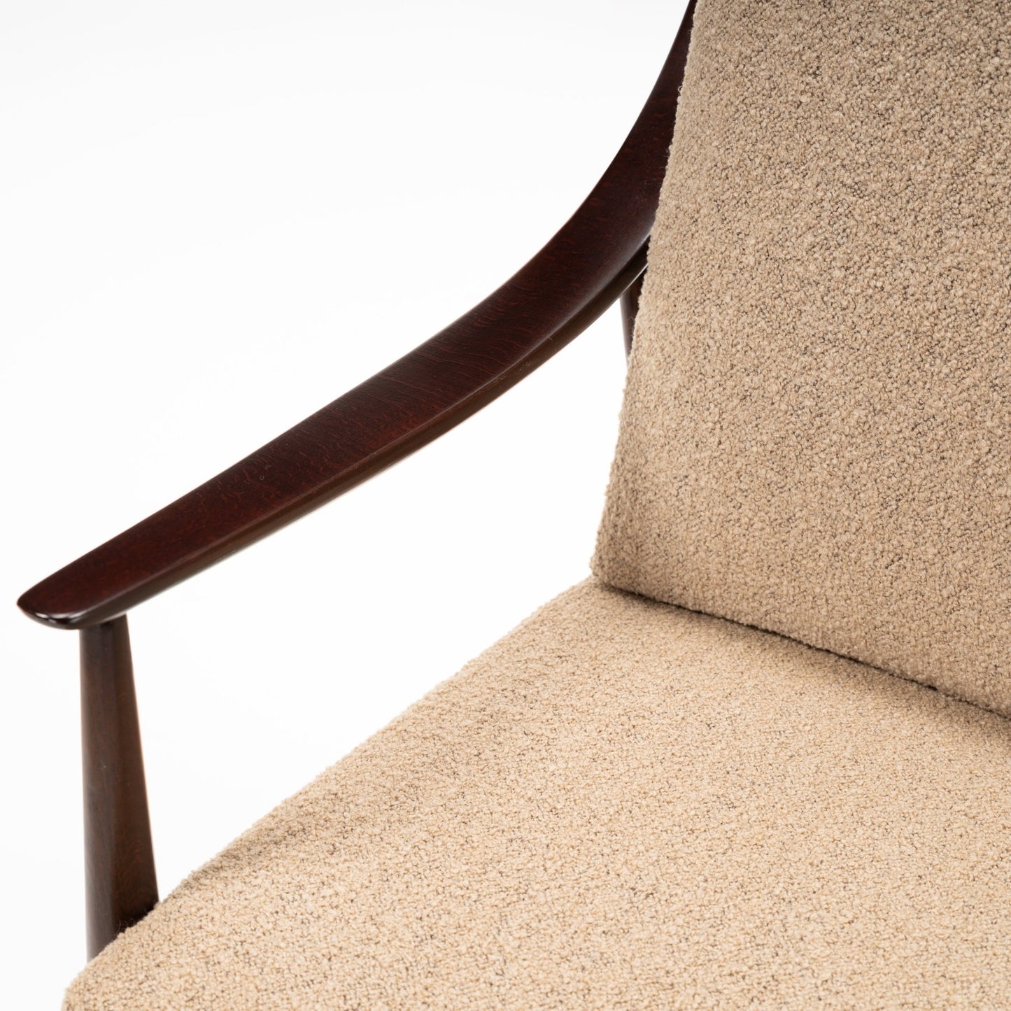 Peter Hvidt Model FD 145 Lounge Chair close detail with sculpted dark wood arm and textured beige upholstery in vintage Danish furniture style