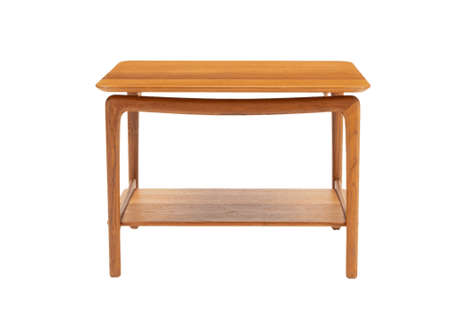 Peter Hvidt & Molgaard teak side table with sculpted legs and lower shelf on white background