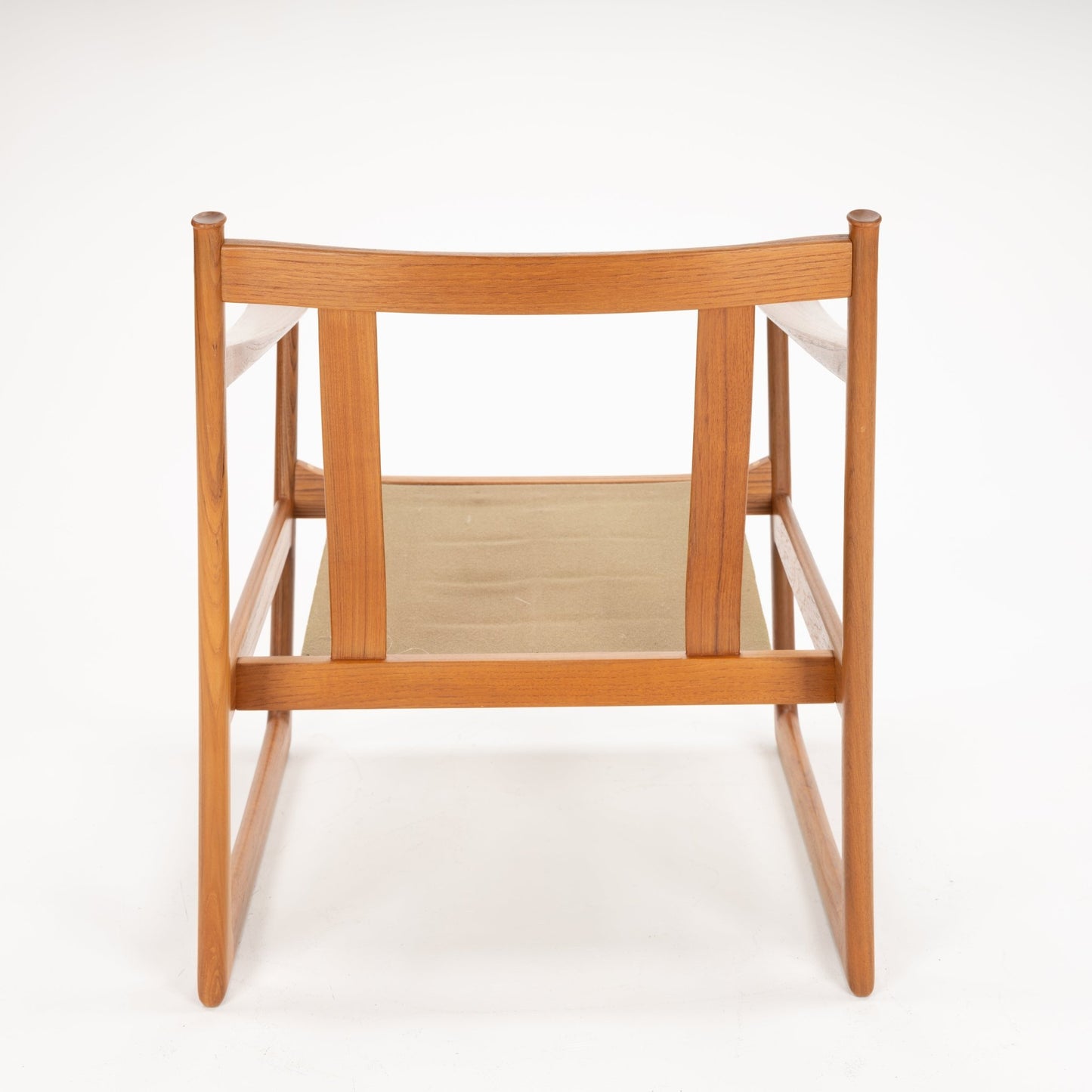 Rear view of a wooden chair frame with vertical slats and a beige fabric seat sling on a white background