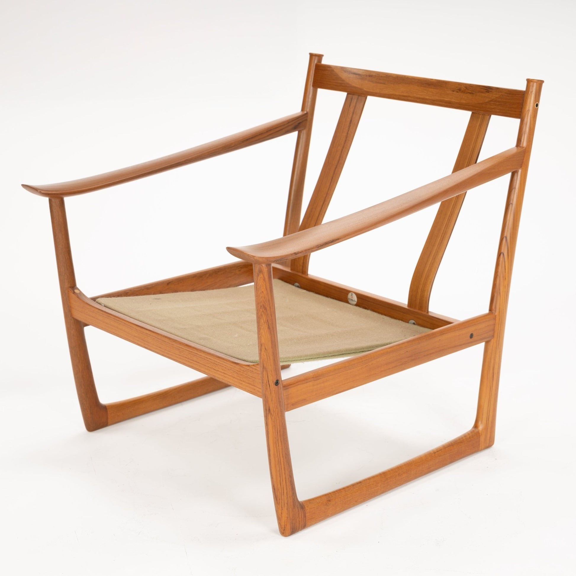 Minimalist wooden chair frame with angled armrests and beige fabric seat sling on white background