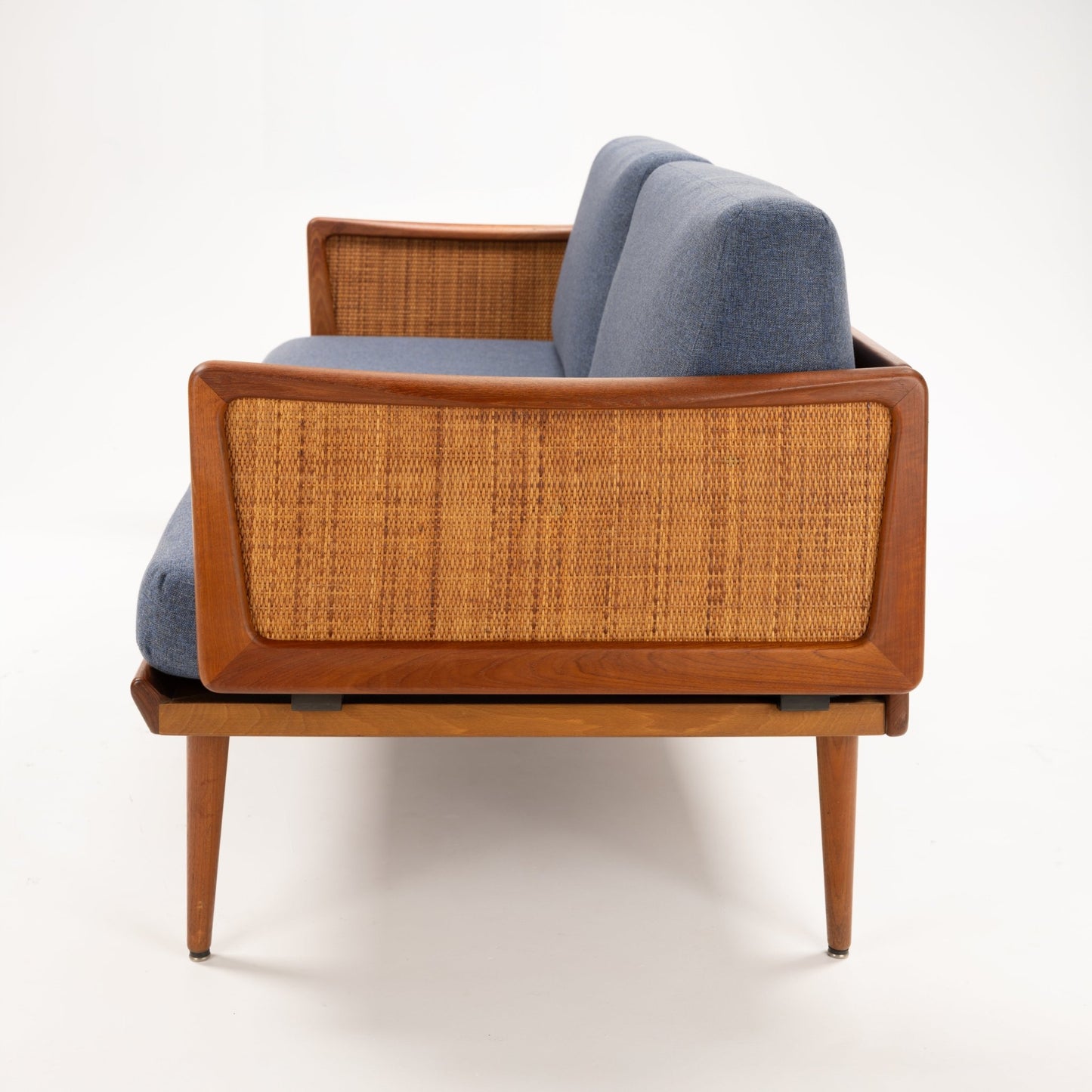 Peter Hvidt & Orla Molgaard Model FD 451 Daybed/Sofa rear view with blue cushions woven cane panels and tapered teak legs in vintage Danish furniture style