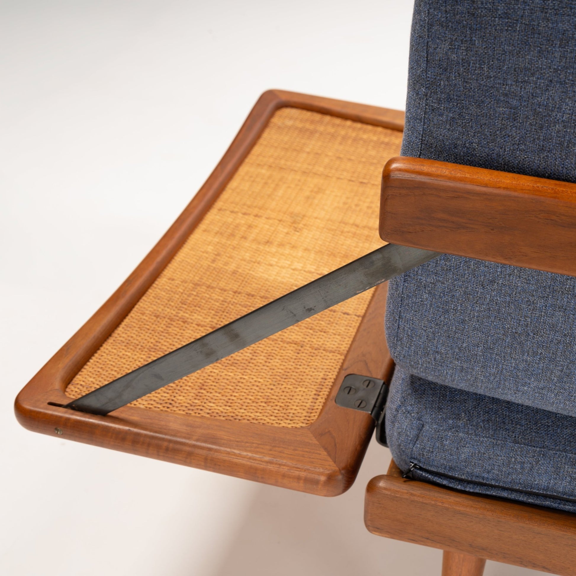 Peter Hvidt & Orla Molgaard Model FD 451 Daybed/Sofa close up of woven cane side panel teak armrest blue upholstery and dark metal support in vintage Danish furniture style