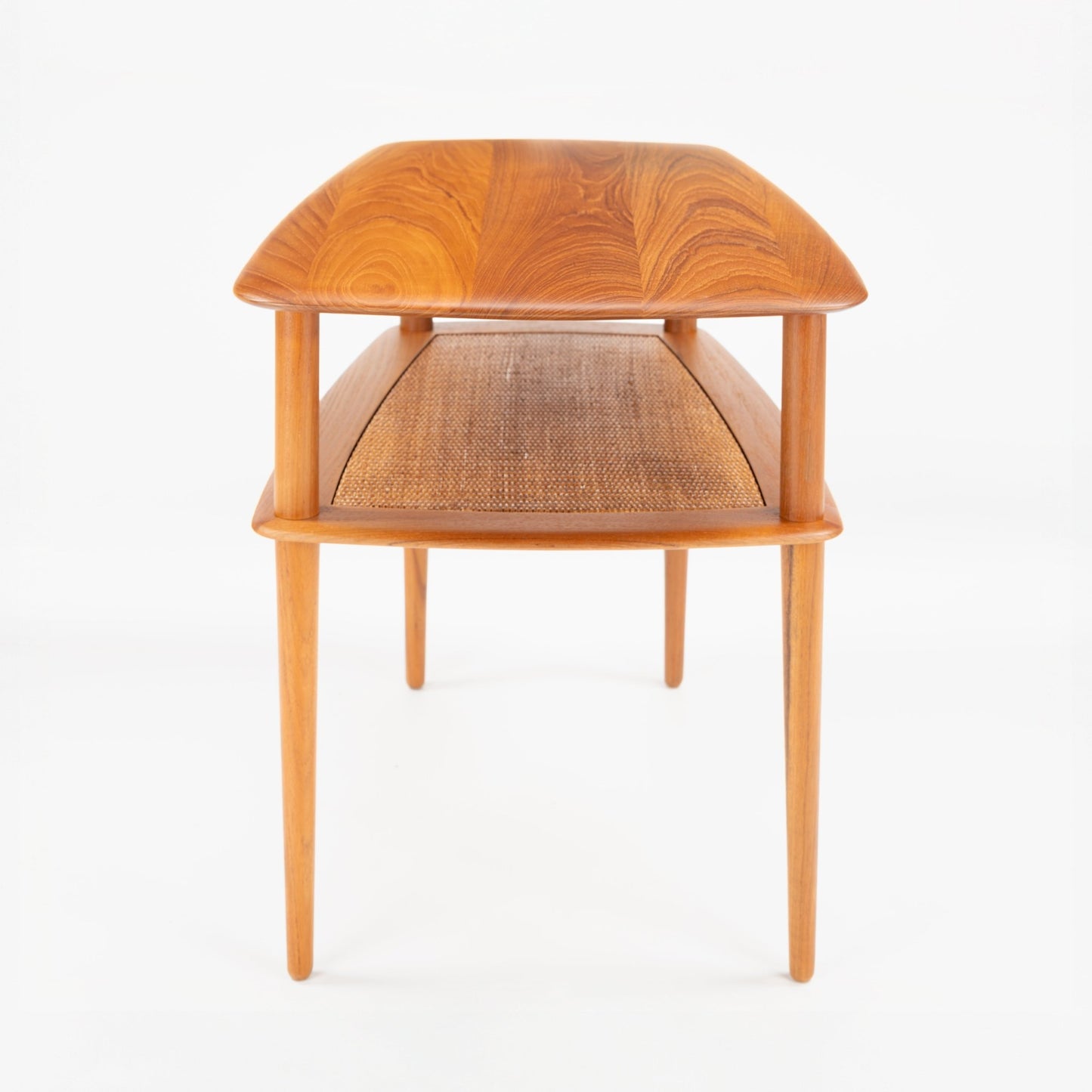 Peter Hvidt & Orla Molgaard Pair of End Tables featuring gracefully curved wooden tops with distinct grain patterns, woven cane storage shelves, and slender legs in vintage Danish mid century modern style.
