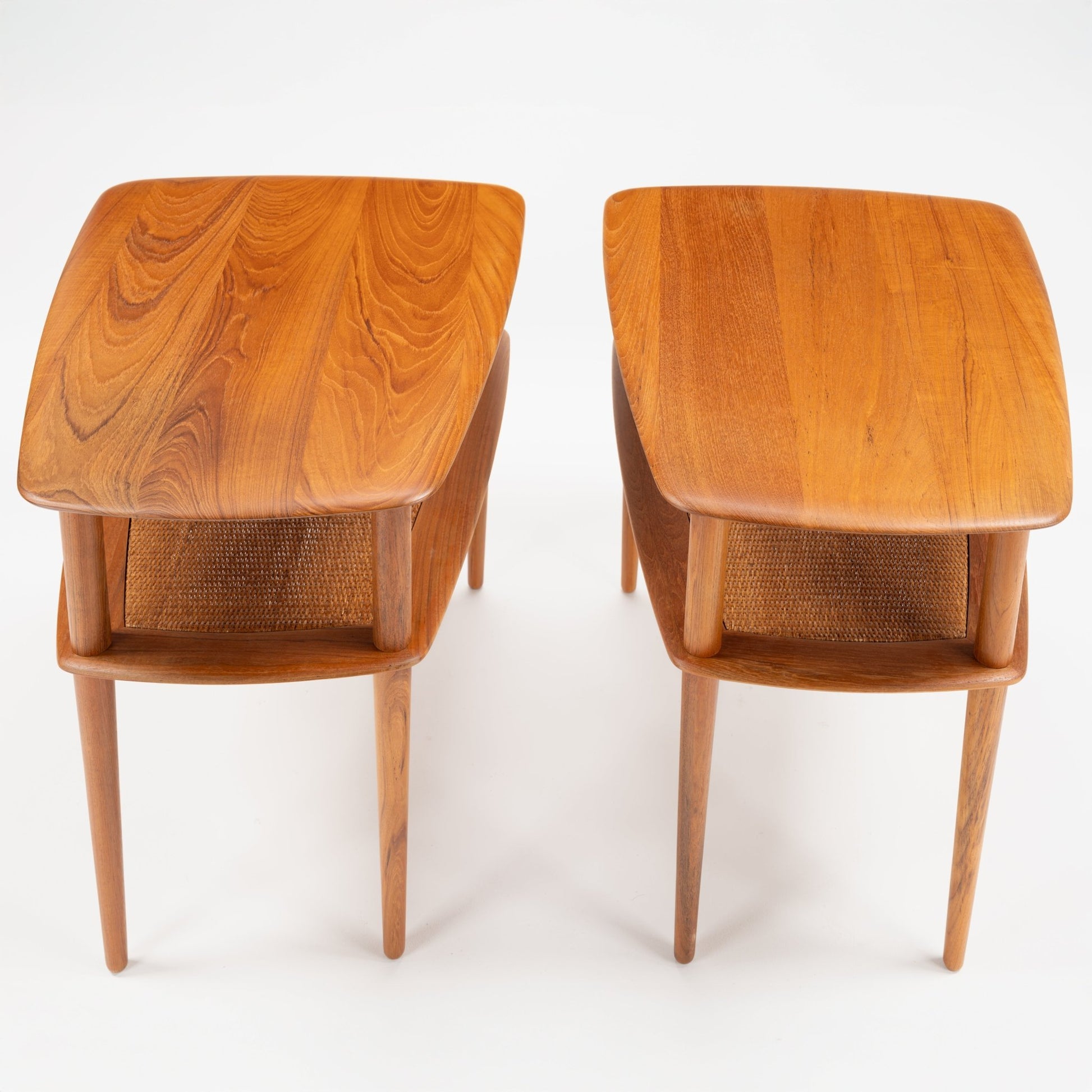 Peter Hvidt & Orla Molgaard Pair of End Tables with sculpted wooden tops showcasing rich grain patterns and woven lower shelves, supported by sleek, tapered legs in mid century modern style