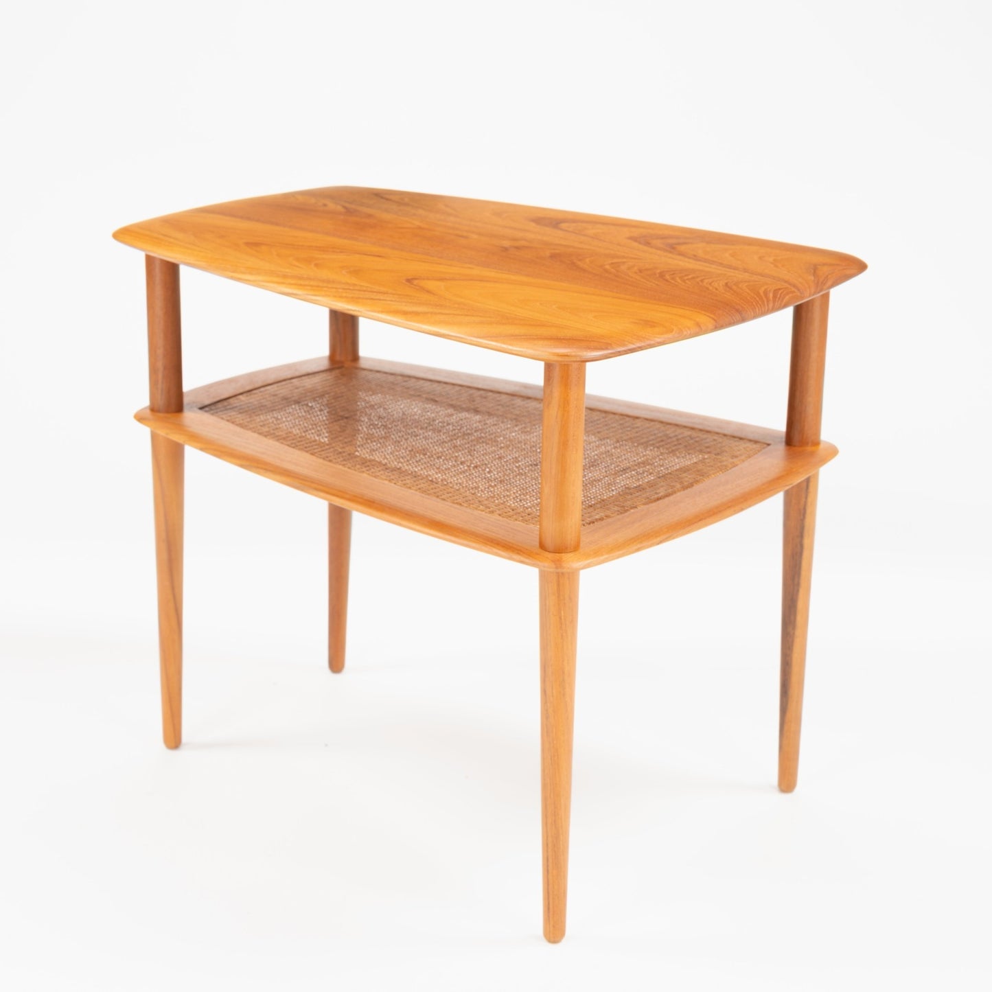 Peter Hvidt & Orla Molgaard Pair of End Tables with gently curved wooden tops showcasing natural grain, woven cane lower shelves, and slender tapered legs in vintage mid century modern style.