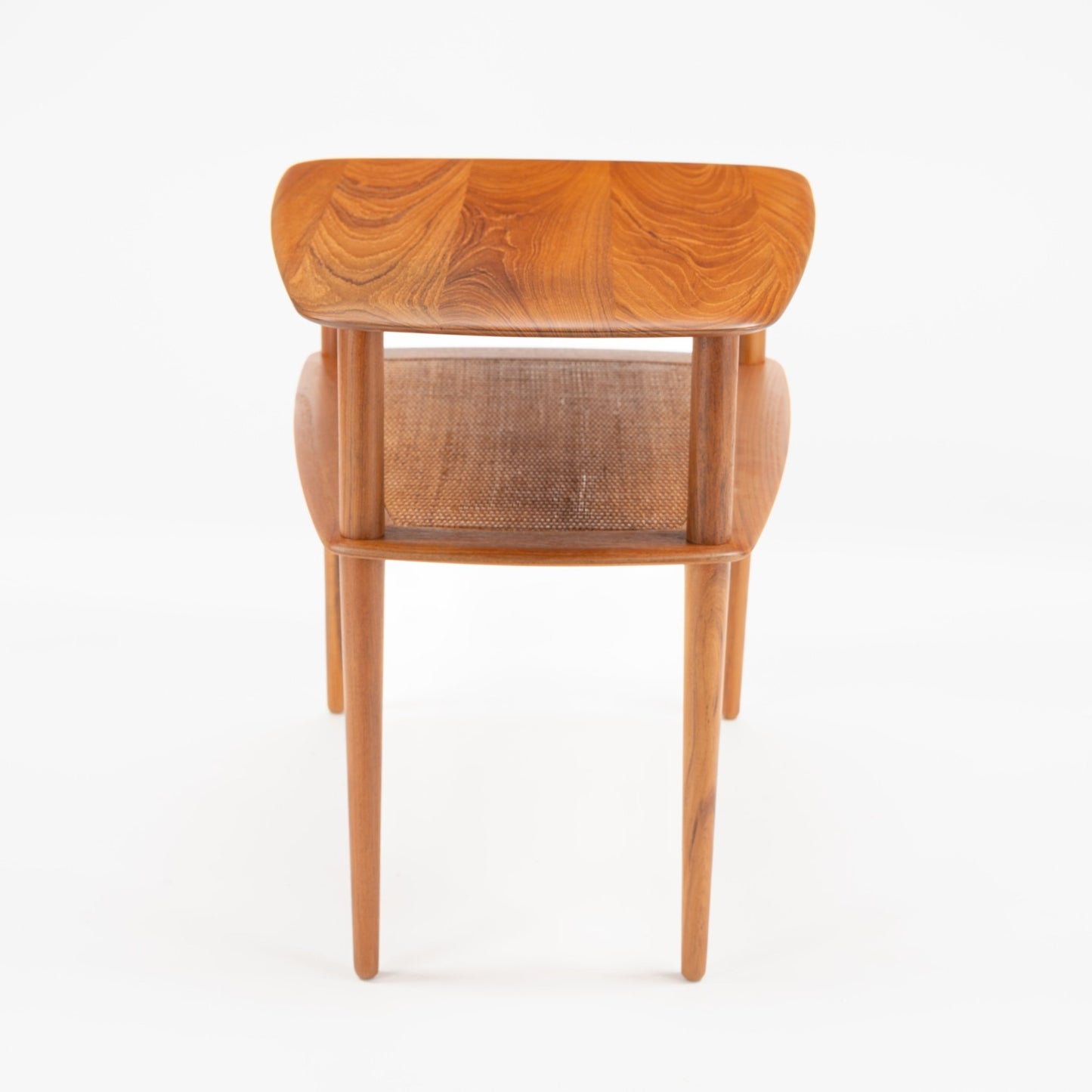 Peter Hvidt & Orla Molgaard Pair of End Tables with sculpted wooden tops displaying intricate grain patterns and a woven shelf under slender, tapered legs in mid century modern style.