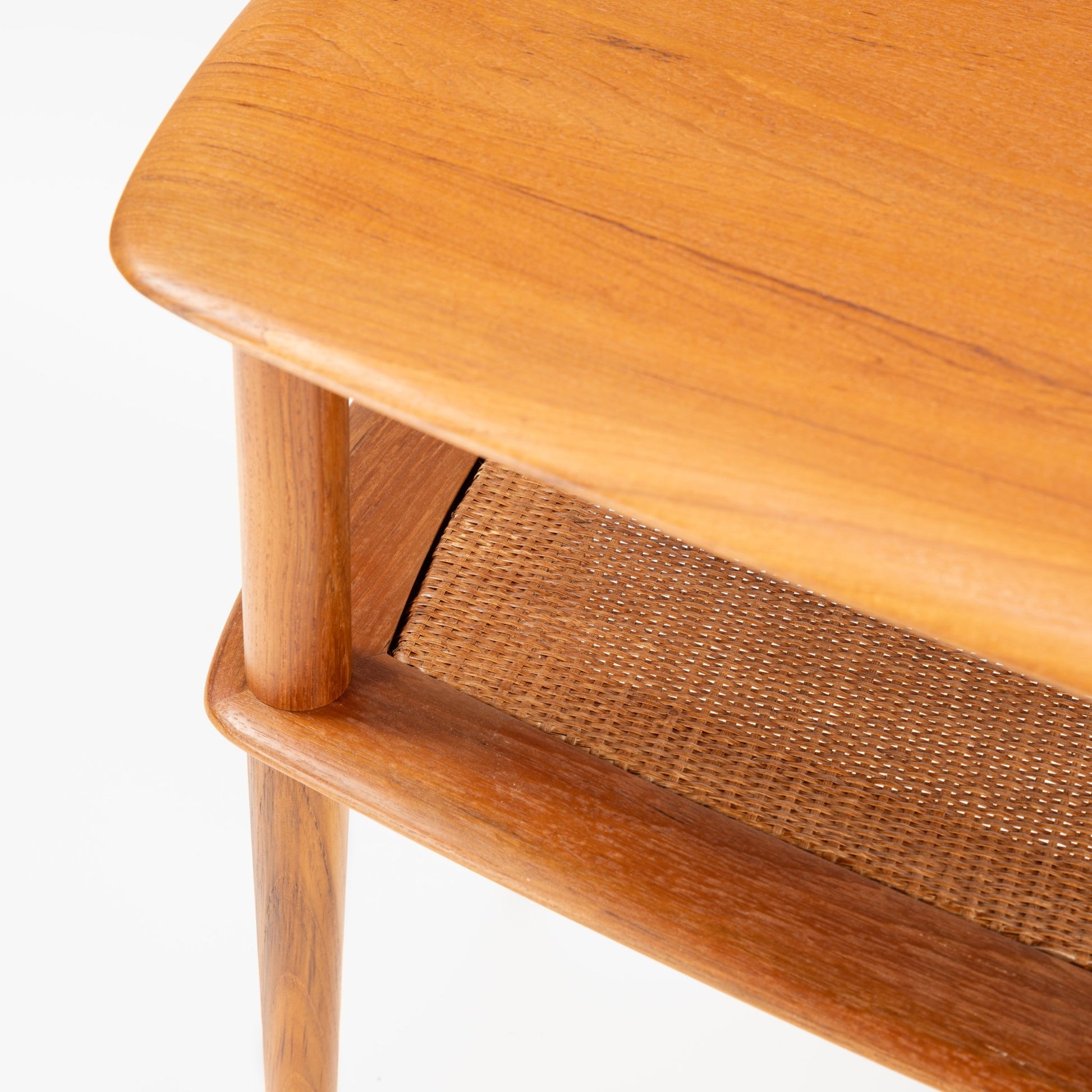Peter Hvidt & Orla Molgaard Pair of End Tables highlighting a warm wooden top with smooth rounded edges, a finely woven cane shelf beneath, and sturdy, tapered legs in mid century modern style.