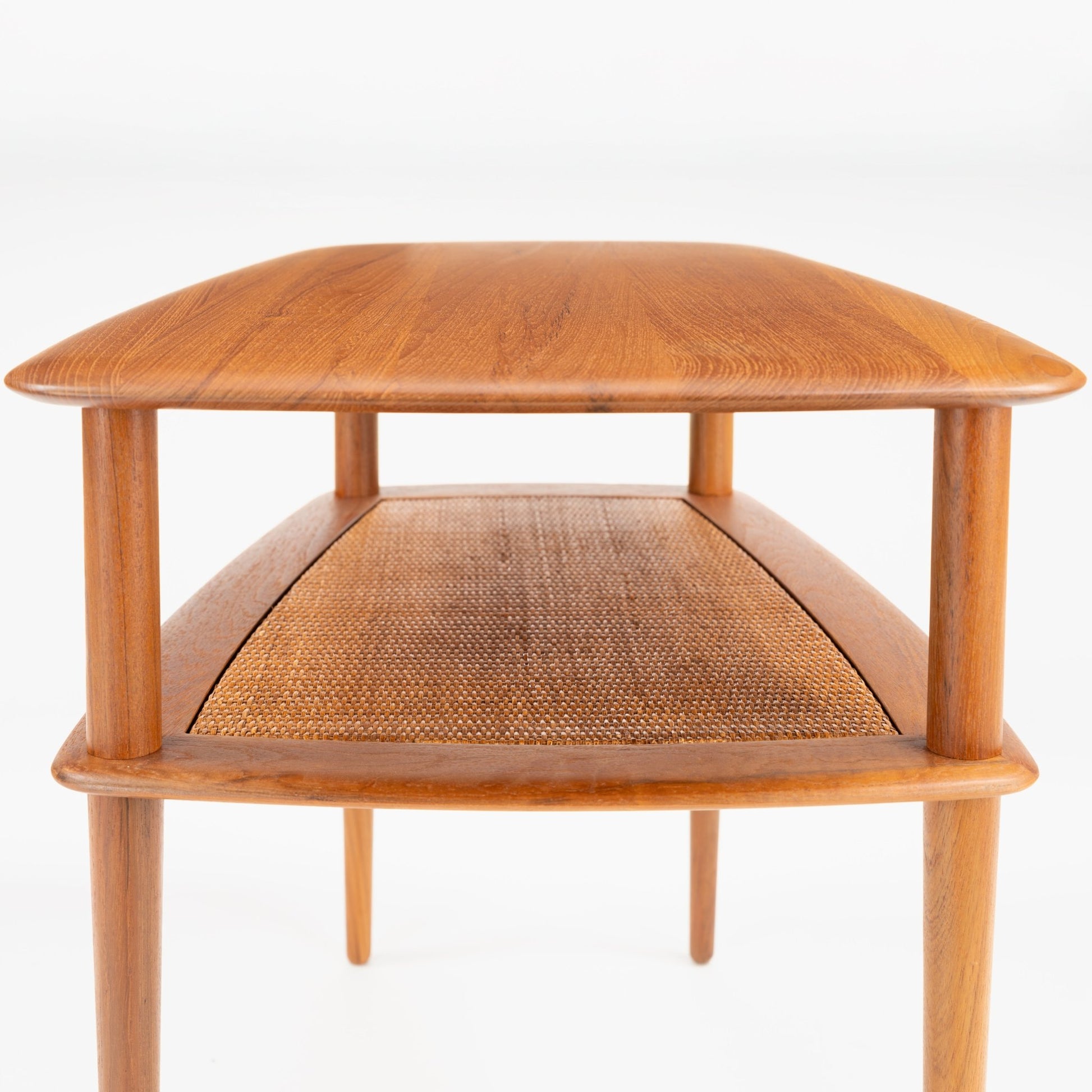 Peter Hvidt & Orla Molgaard Pair of End Tables showing a smooth wooden surface with gently rounded corners, supported by slender legs and a finely woven cane shelf beneath in vintage mid century modern style.