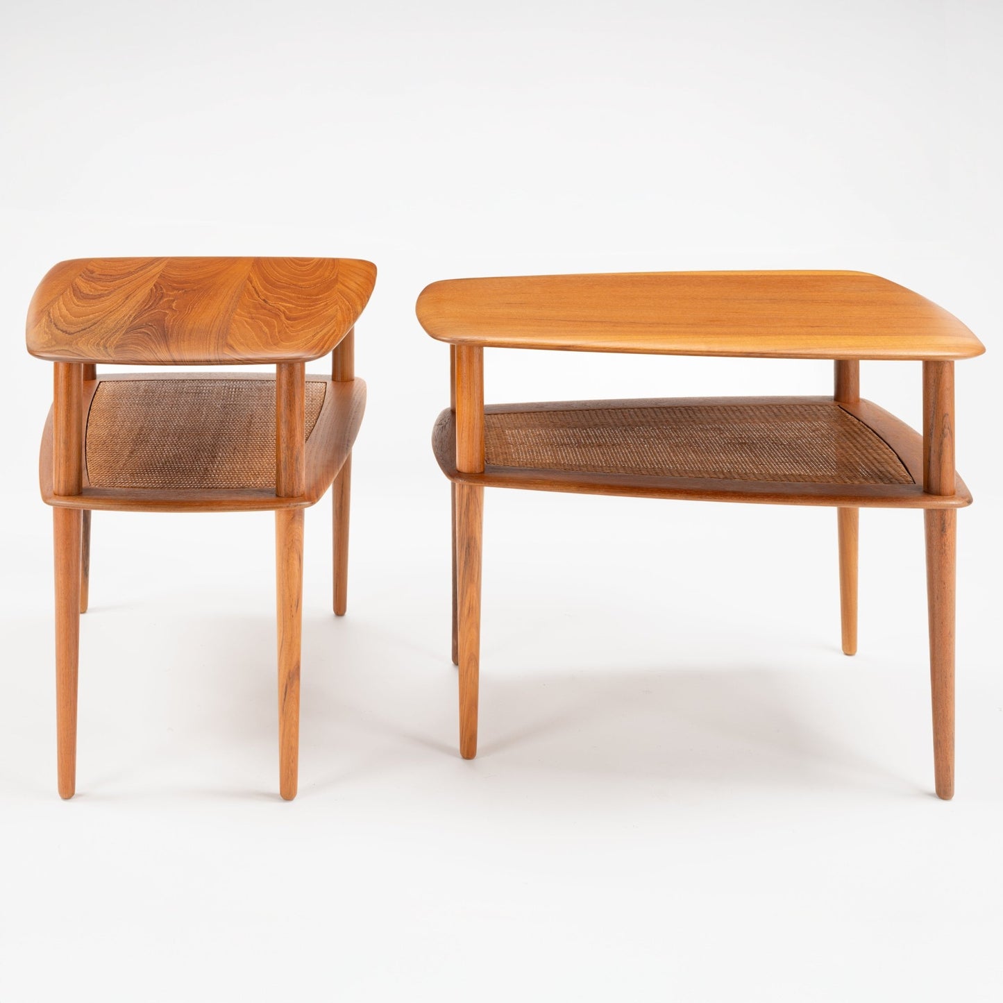 Peter Hvidt & Orla Molgaard Pair of End Tables displaying warm wooden surfaces with rounded edges and a woven lower shelf, supported by slender, tapered legs in a refined mid century modern design.