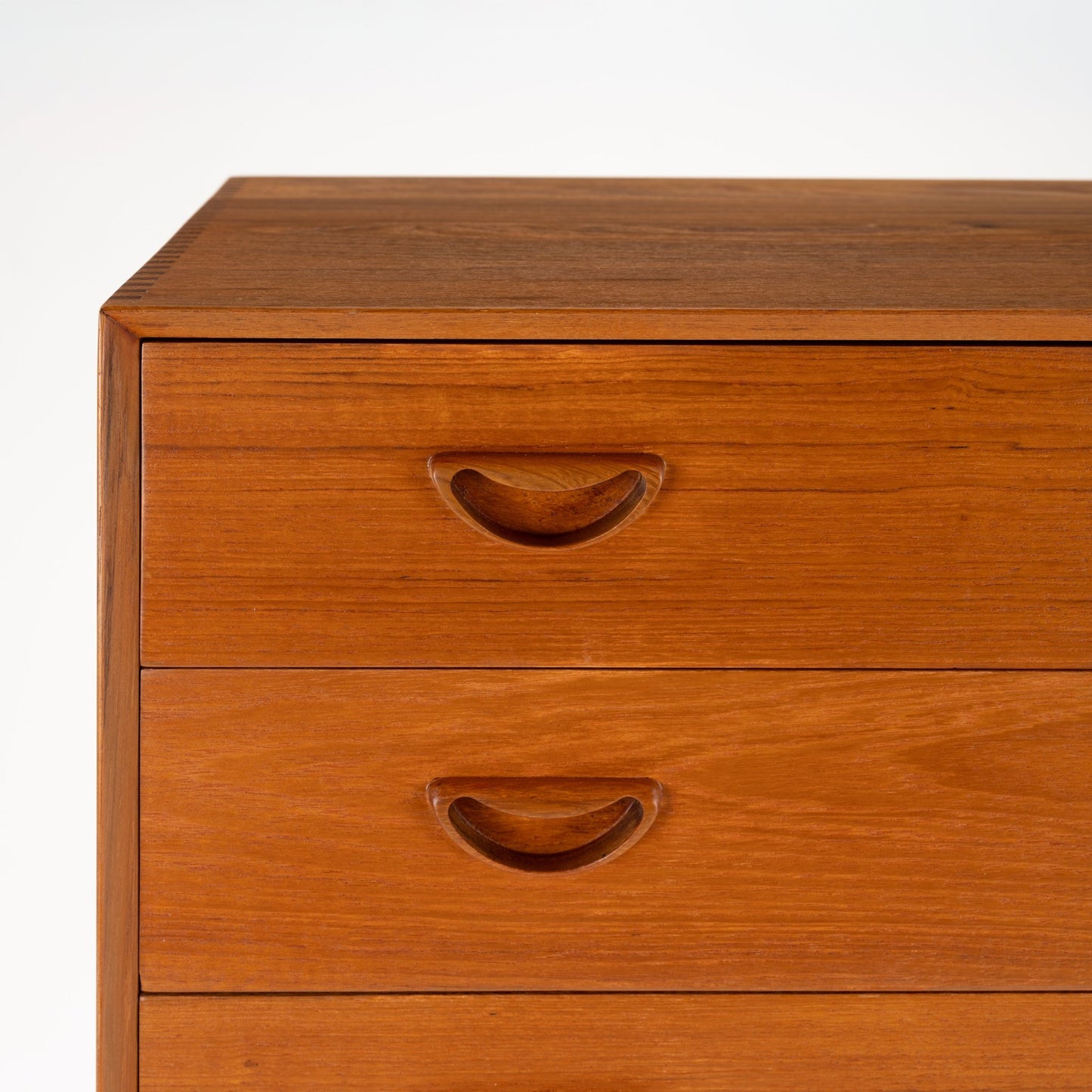 Peter Hvidt & Orla Nielsen Teak Chest of Drawers showcasing rich teak wood with handcrafted recessed curved handles, highlighting sleek lines and expert vintage Danish mid century modern storage design.