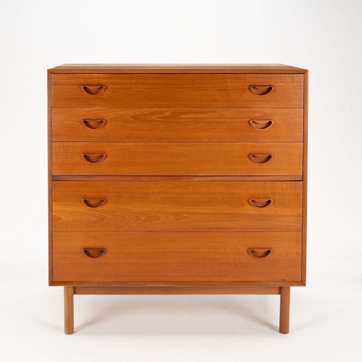 Peter Hvidt & Orla Nielsen Teak Chest of Drawers featuring warm teak wood with five drawers, simple recessed handles, and a minimalist mid century modern storage design.