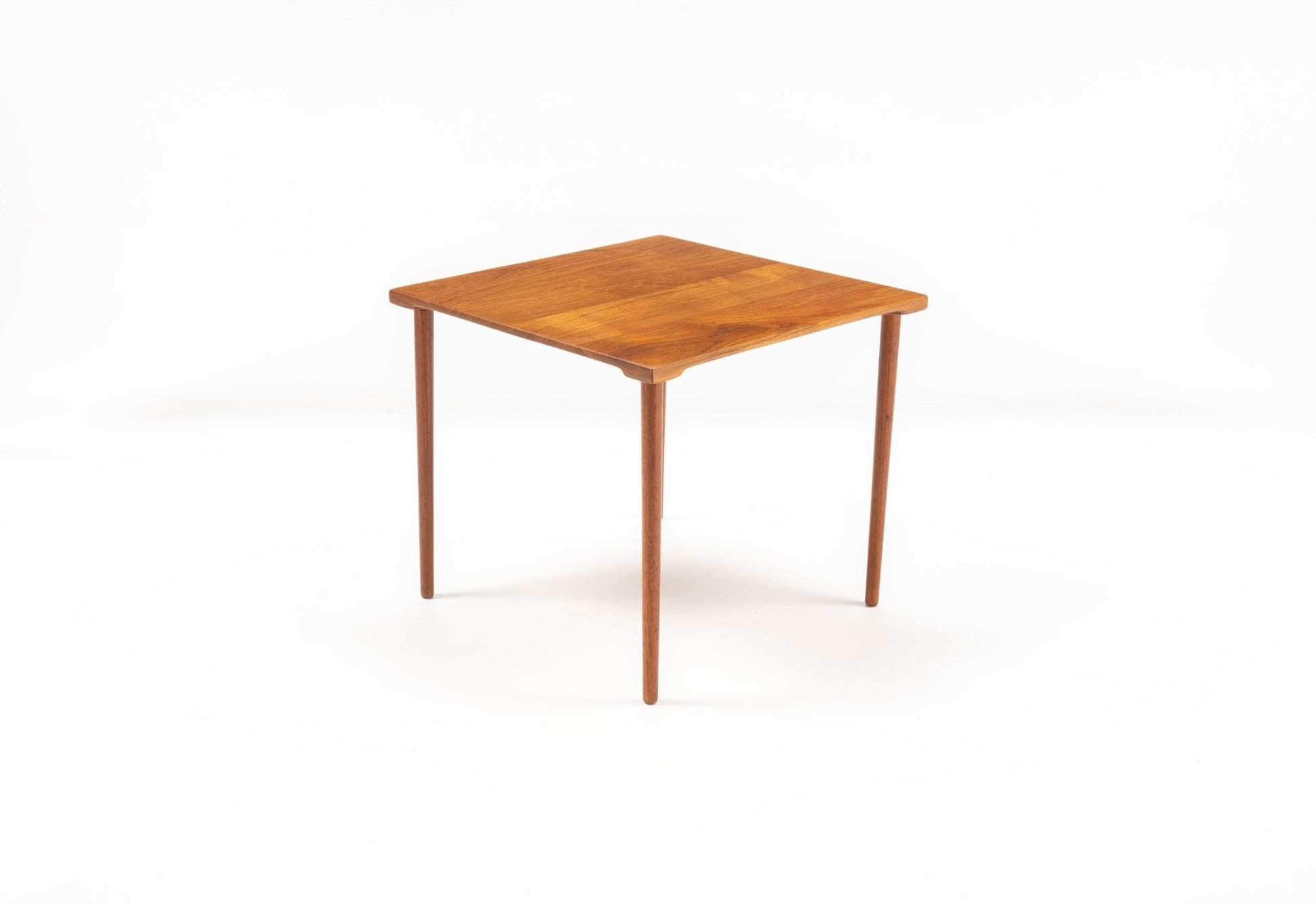 1960s Danish teak side table by Peter Hvidt with slender dowel legs and single slab top on white background