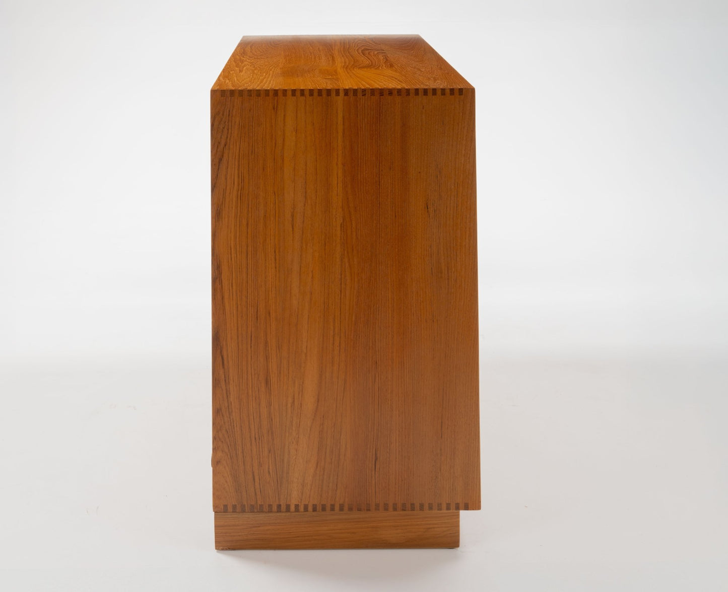 Side view of Peter Hvidt solid teak five-drawer dresser with clean Danish modern lines and dovetail joinery detail