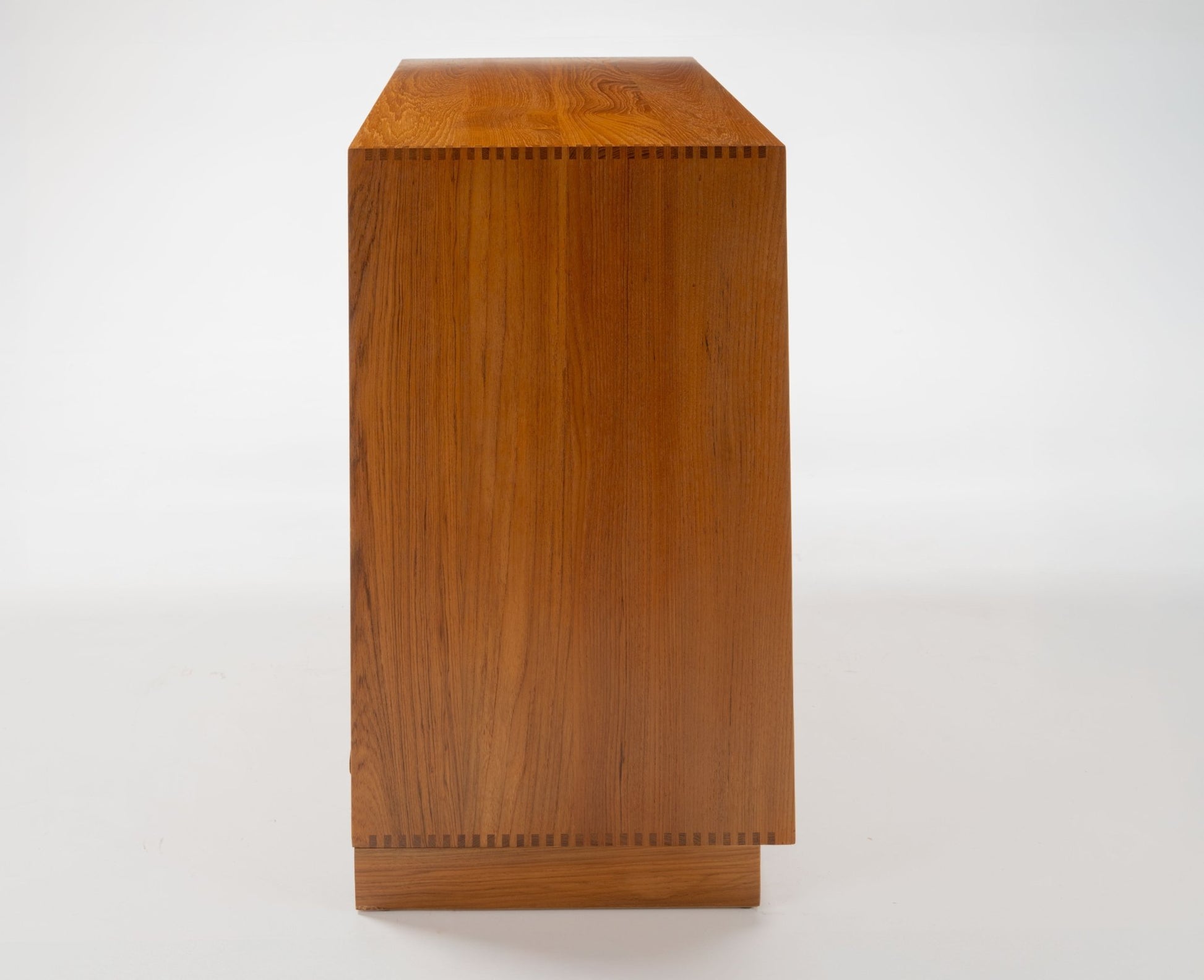 Side view of Peter Hvidt solid teak five-drawer dresser with clean Danish modern lines and dovetail joinery detail