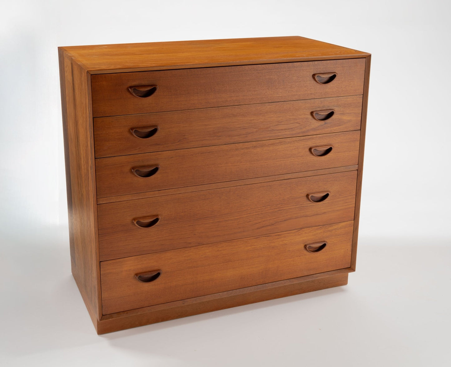 Peter Hvidt solid teak five-drawer dresser with minimalist Danish design and recessed handles from mid-century Denmark.