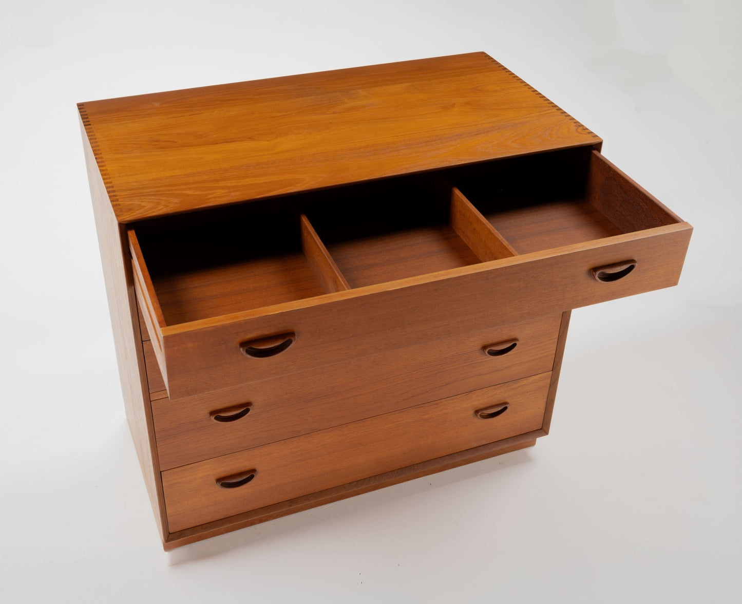 Peter Hvidt solid teak mid-century dresser with three drawers, featuring clean Danish design and wooden handles.