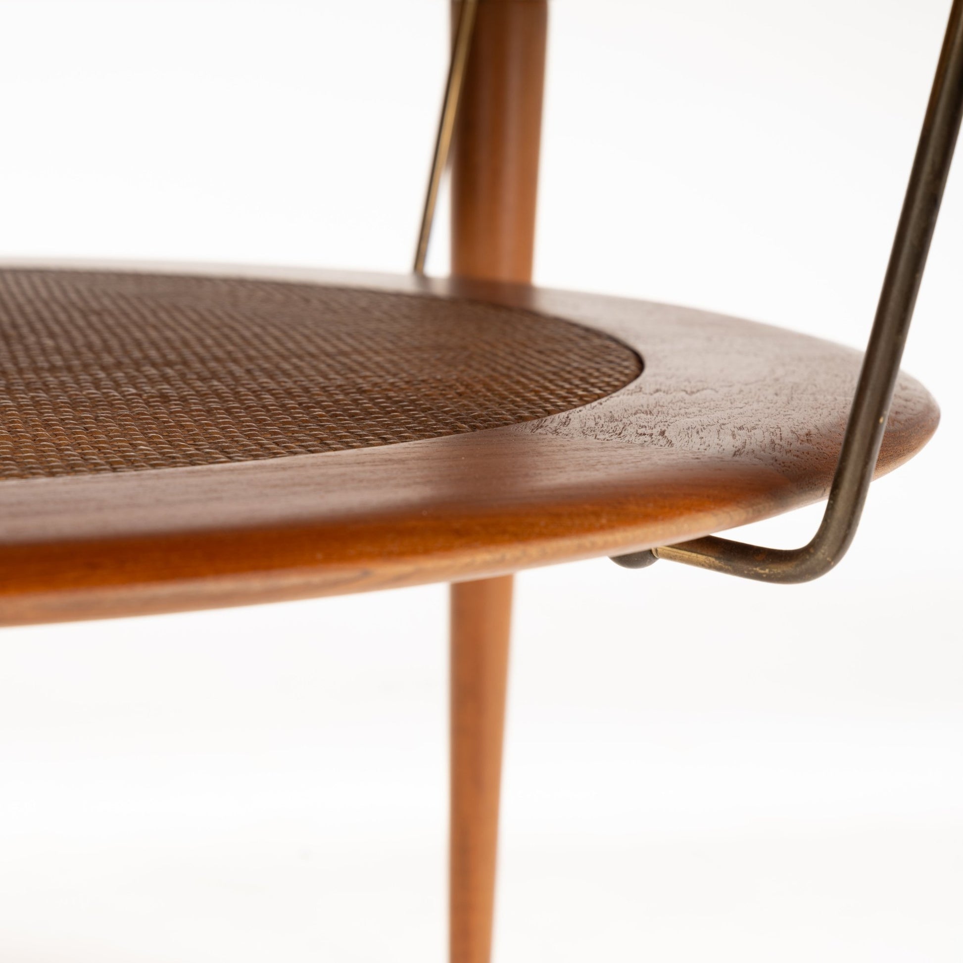 Peter Hvidt Teak Coffee Table Model FD-515 displaying a close-up of its rounded teak edge and finely woven cane lower shelf supported by slim legs, highlighting vintage mid century modern woodwork.