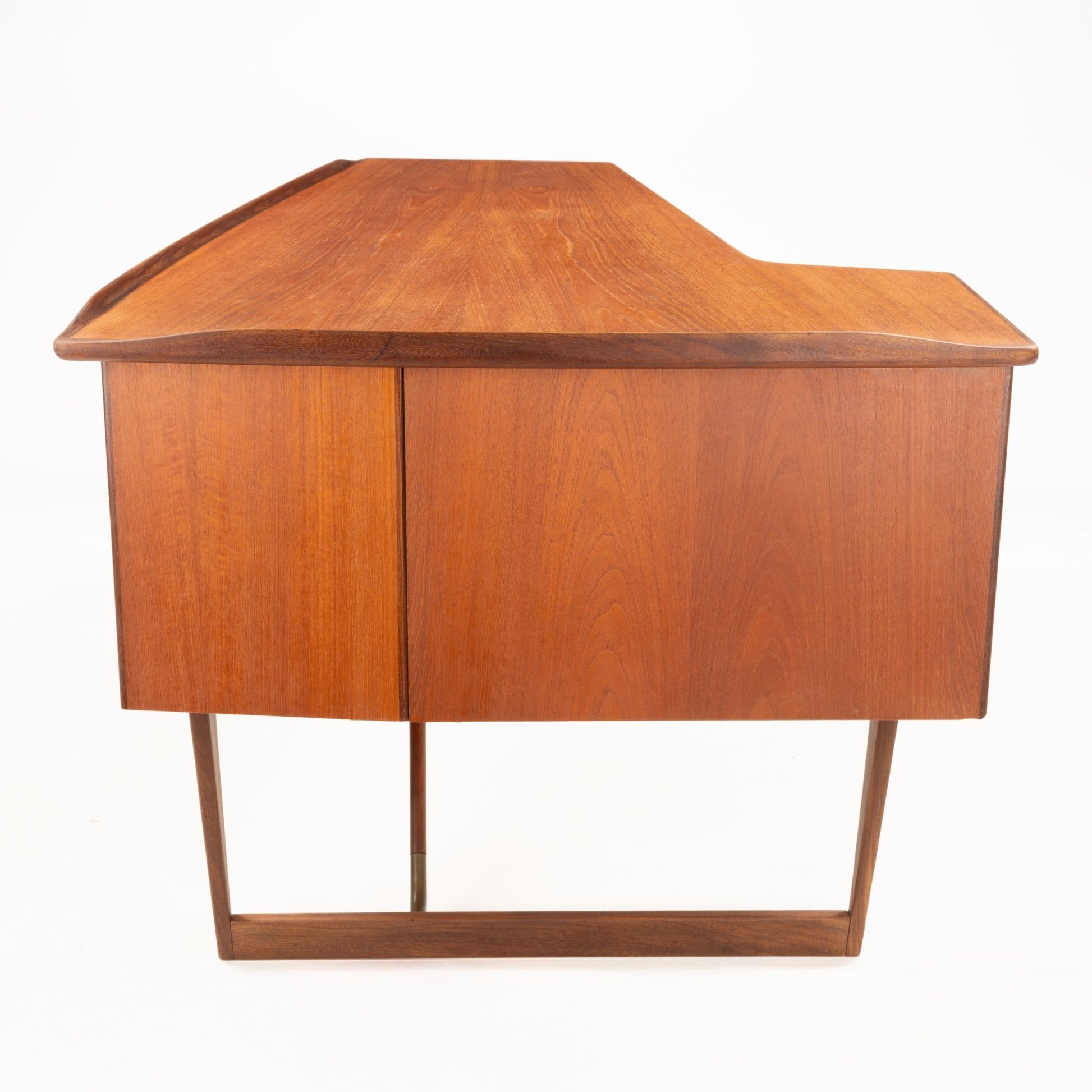 1960s Danish teak writing desk with oversized asymmetrical boomerang top and slender tapered base