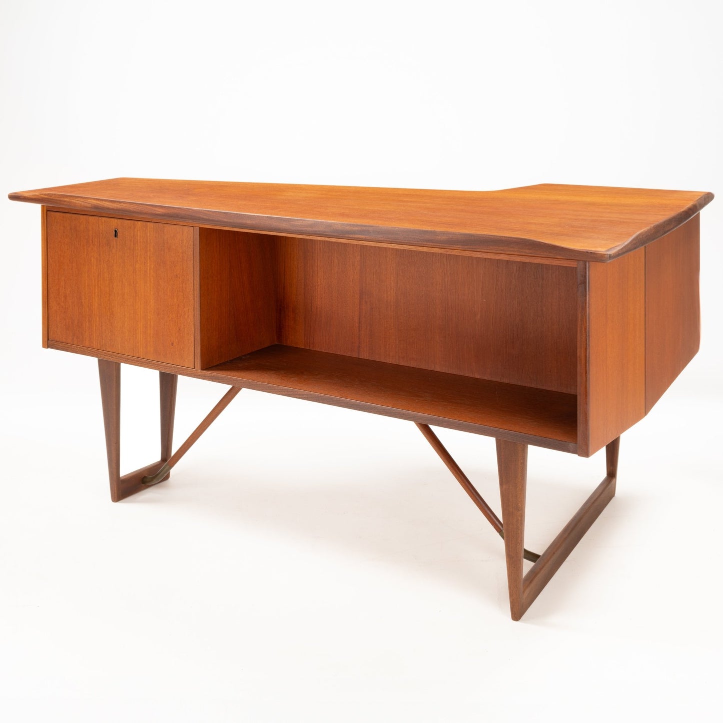 1960s Danish teak writing desk with sculptural asymmetrical boomerang top and open storage compartment on geometric base