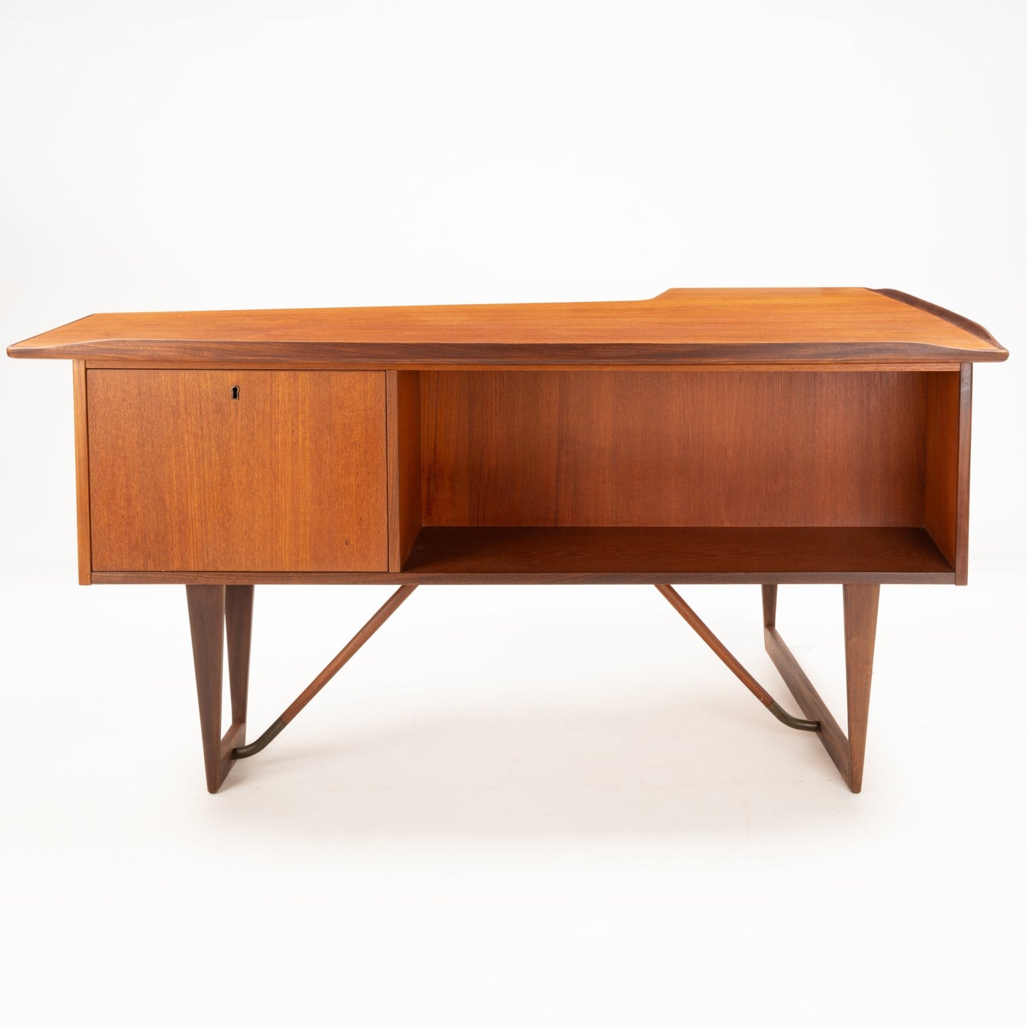 1960s Danish teak writing desk with asymmetrical boomerang top, storage cabinet, open shelf, and tapered legs