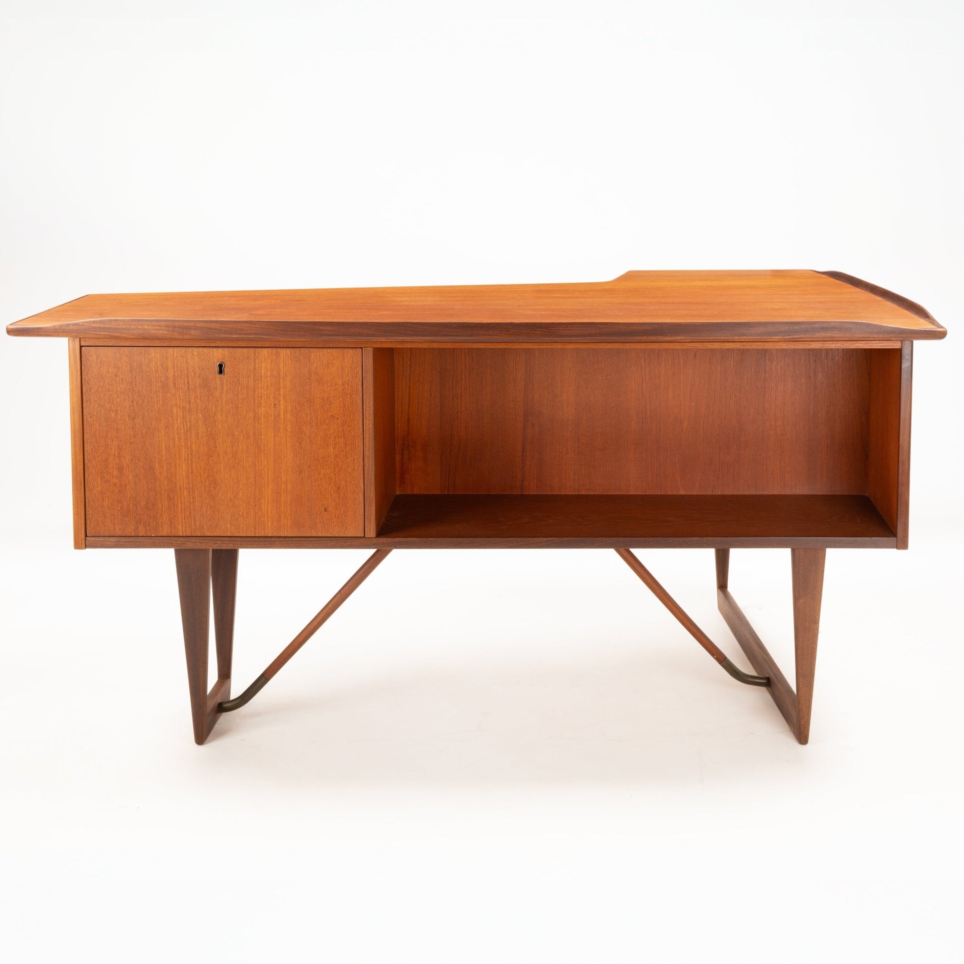1960s Danish teak writing desk with asymmetrical boomerang top, storage cabinet, open shelf, and tapered legs