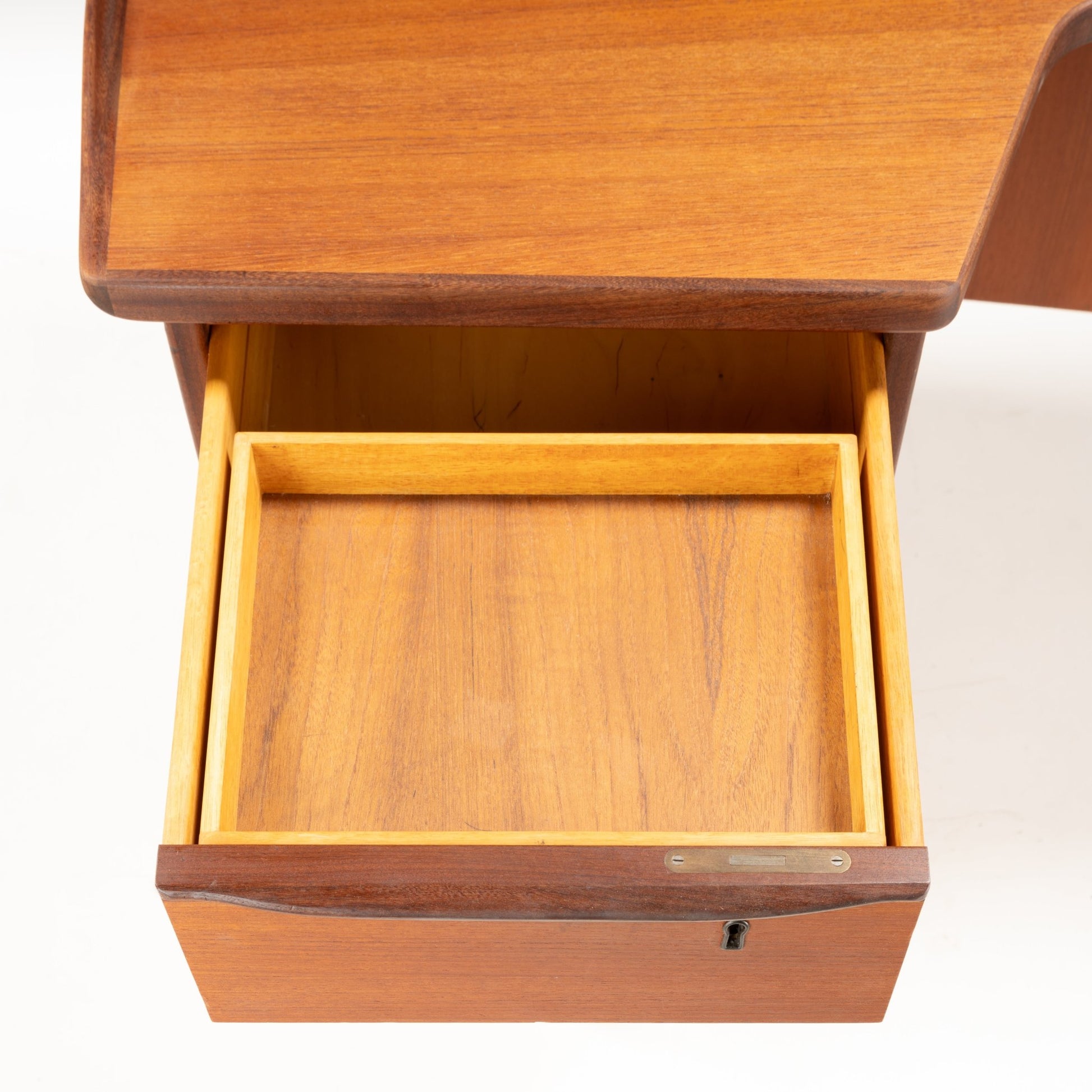 Open drawer of 1960s Danish teak writing desk by Peter Løvig Nielsen showing smooth wood grain and craftsmanship
