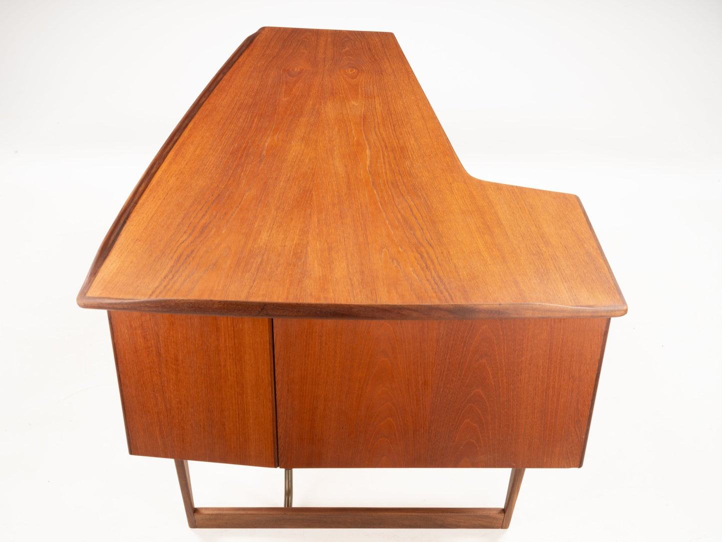 1960s Danish teak writing desk with oversized asymmetrical boomerang-shaped top and wooden cabinet base