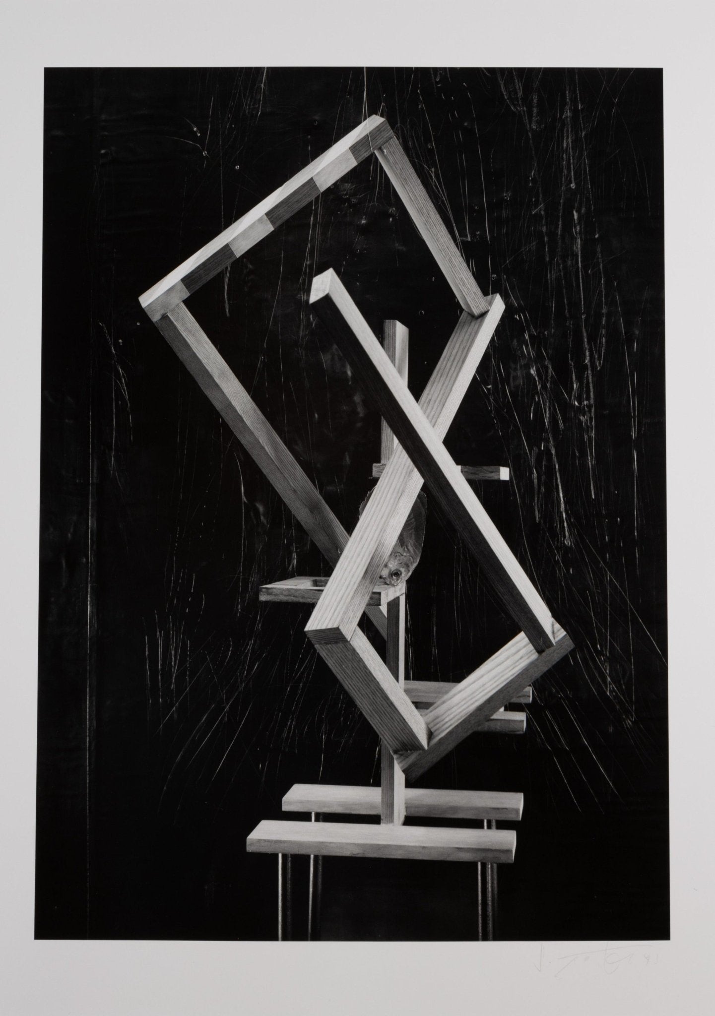 Black and white photograph of abstract wooden geometric sculpture with hand-manipulated textures and black background