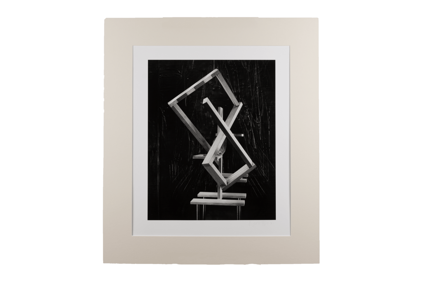 Black and white abstract photograph with hand manipulation, featuring geometric shapes and a neutral matting