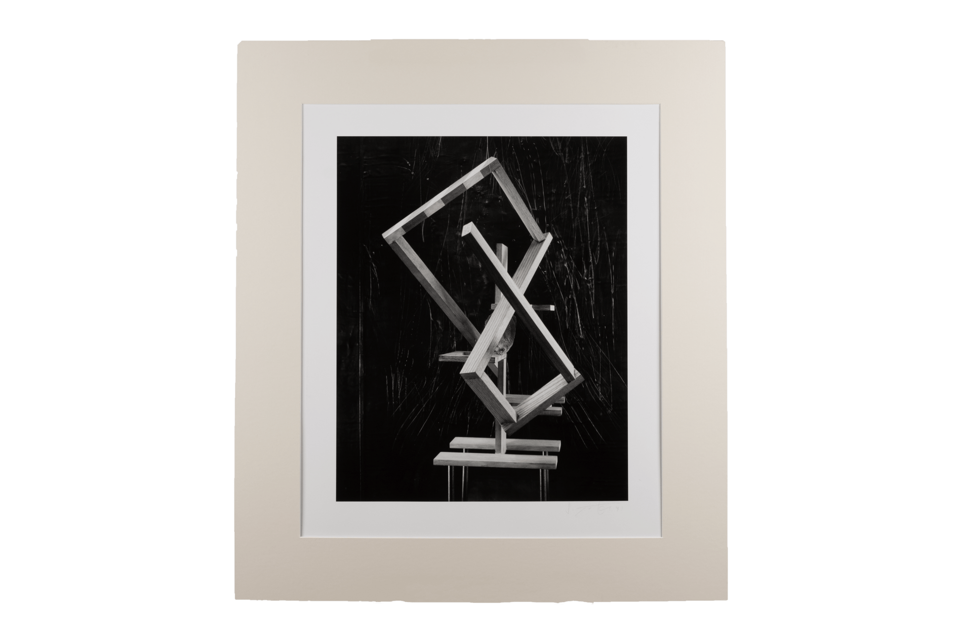 Black and white abstract photograph with hand manipulation, featuring geometric shapes and a neutral matting