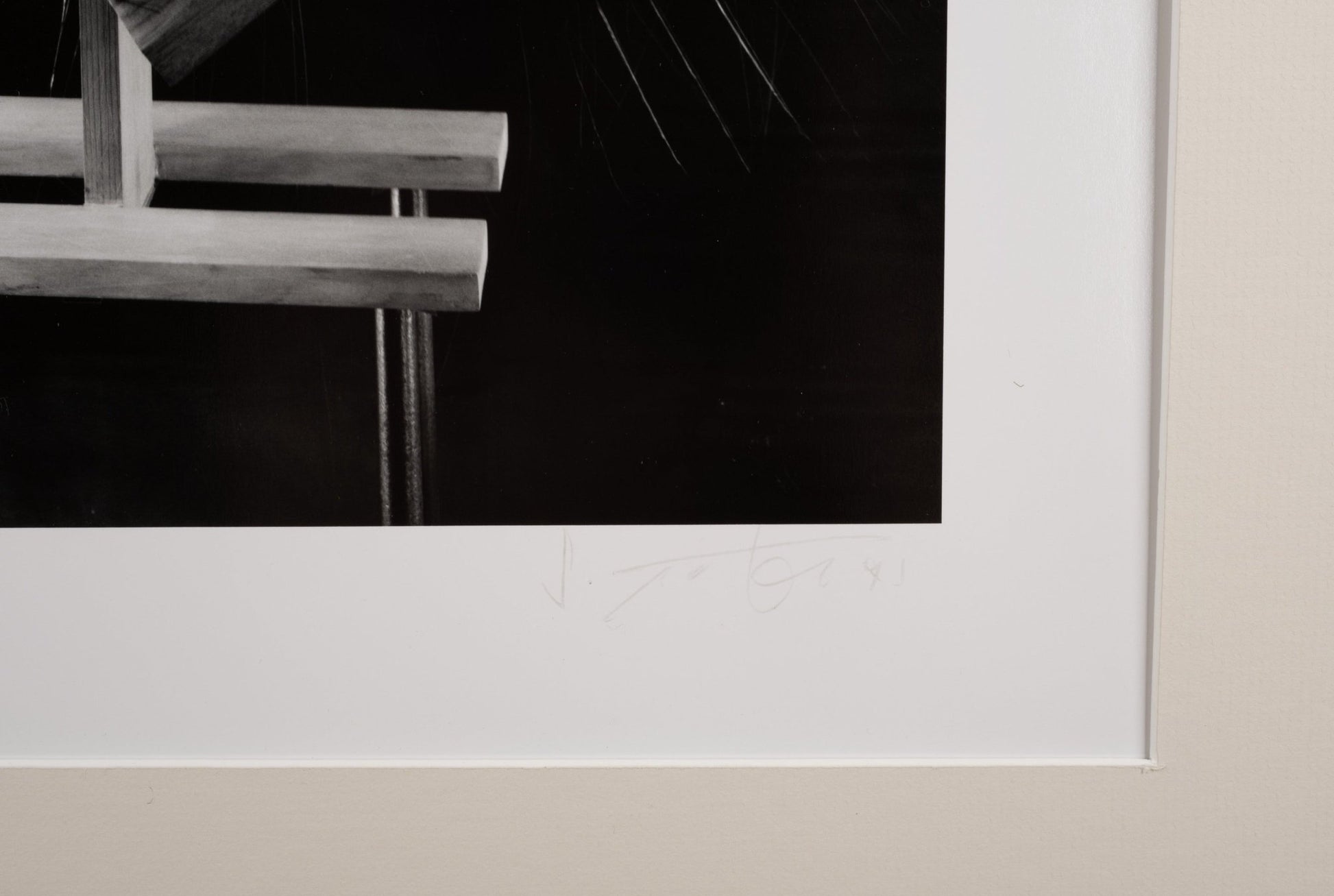 Close-up of black and white photograph with hand manipulation, signed and dated 91, displayed in white matting.