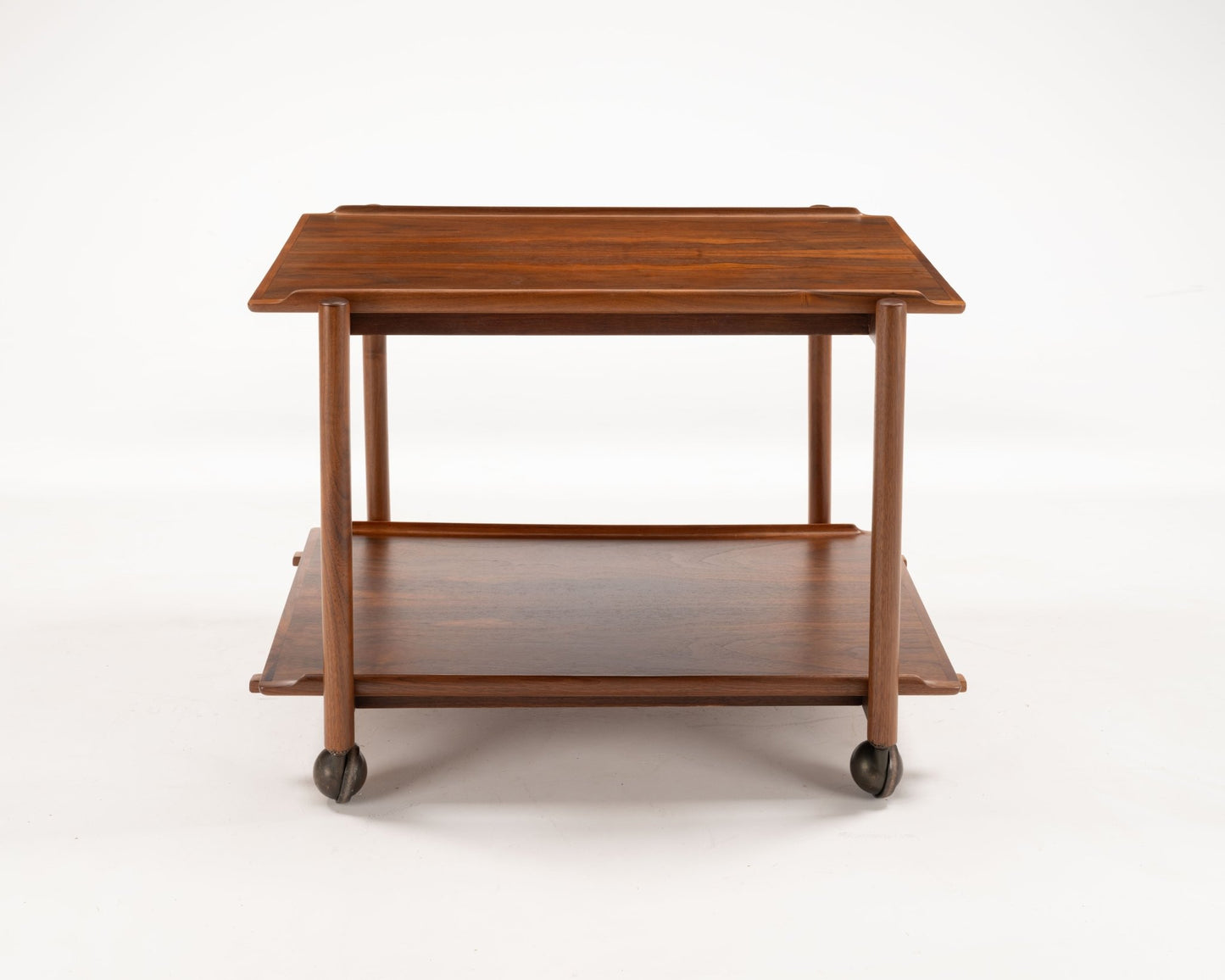 Mid-century modern Poul Hundevad teak bar cart with expandable top and lower shelf on caster wheels from Denmark.