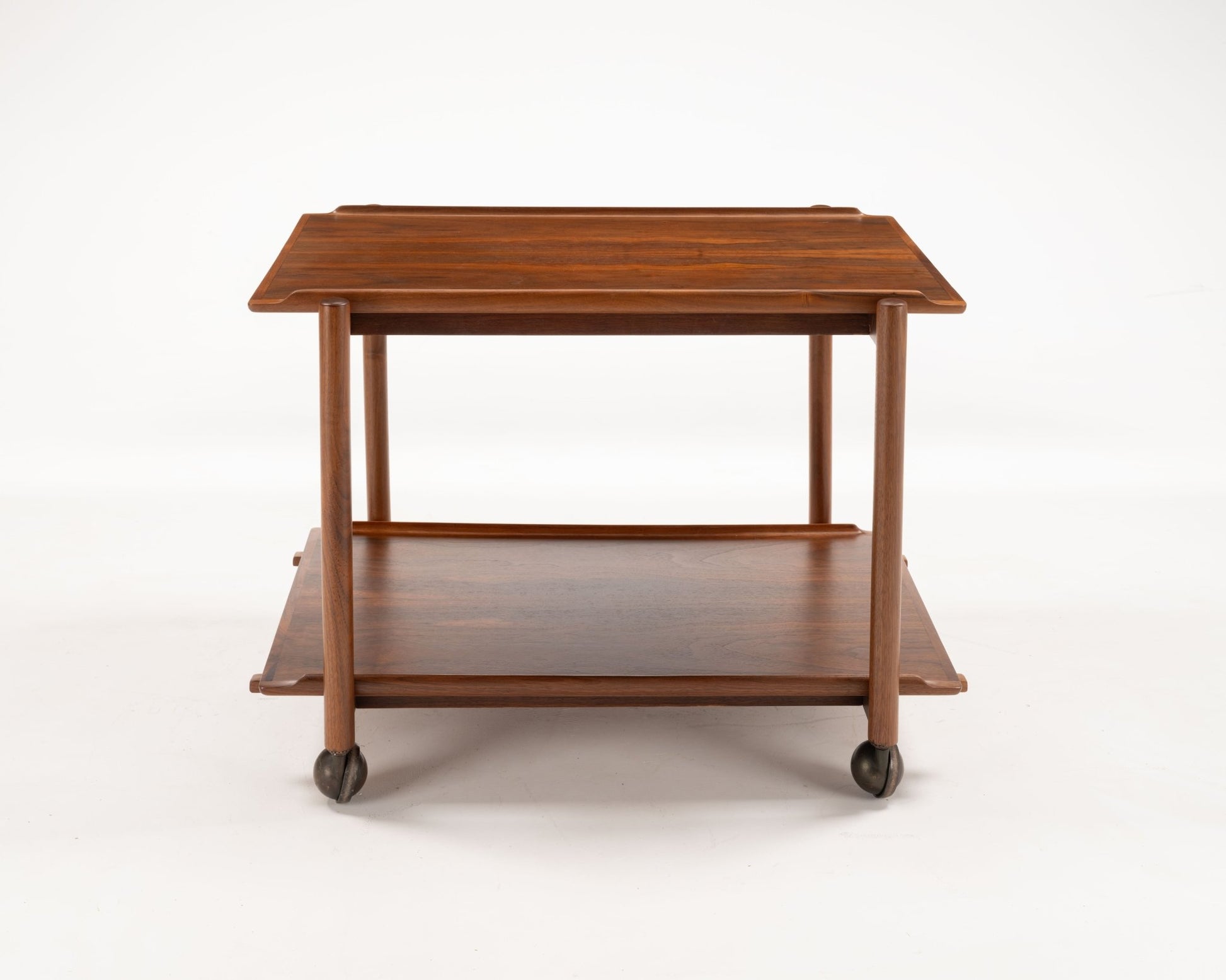 Mid-century modern Poul Hundevad teak bar cart with expandable top and lower shelf on caster wheels from Denmark.