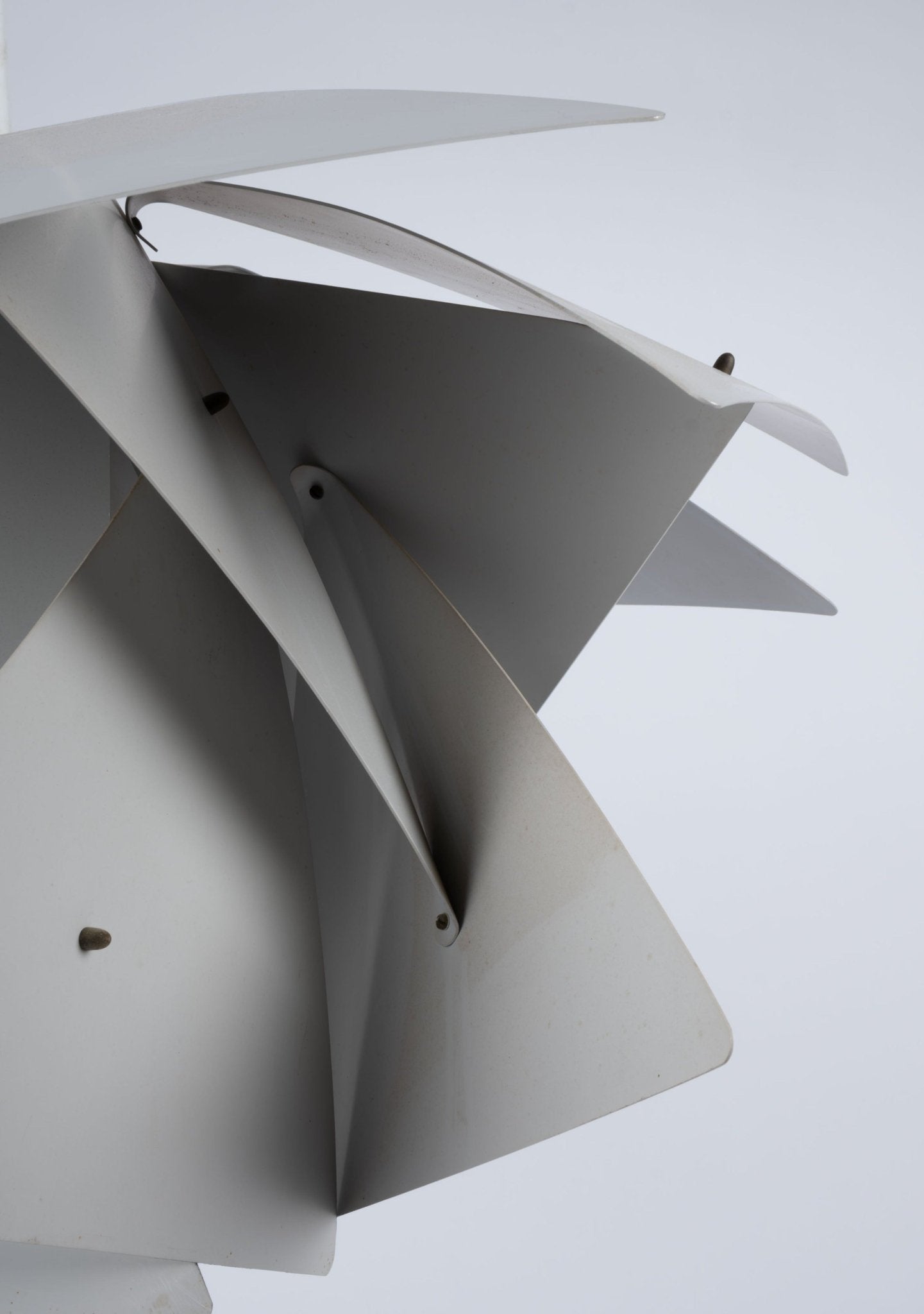 Close-up view of Preben Dal "Trigon" pendant lamp with sculptural white metal panels from the Symfoni series