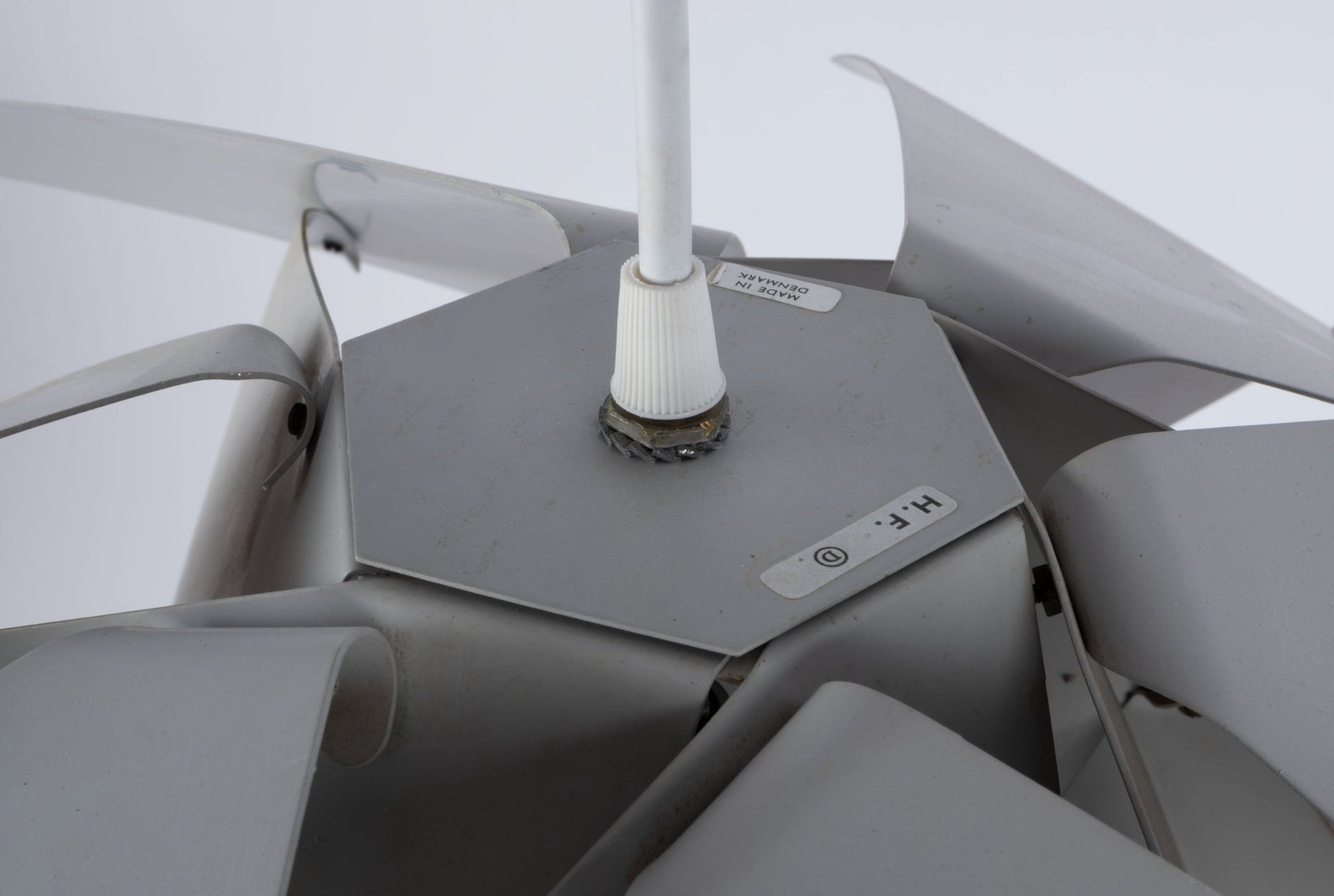 Close-up of Preben Dal "Trigon" Symfoni series pendant lamp showcasing its sculptural metal details and manufacturer logo.