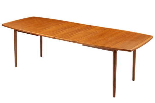 Rastad & Relling Extension Dining Table in warm teak with a long rounded top and tapered wooden legs in mid century modern furniture style