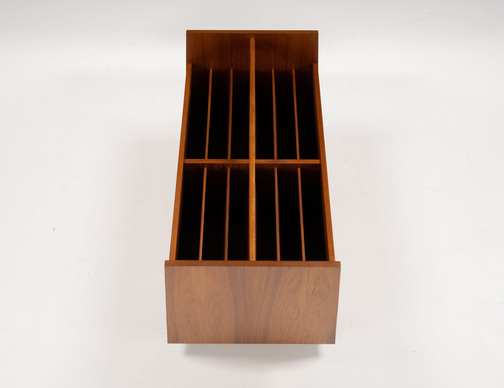 Mid-century modern double-wide teak record and magazine caddy with internal dividers and castor wheels.