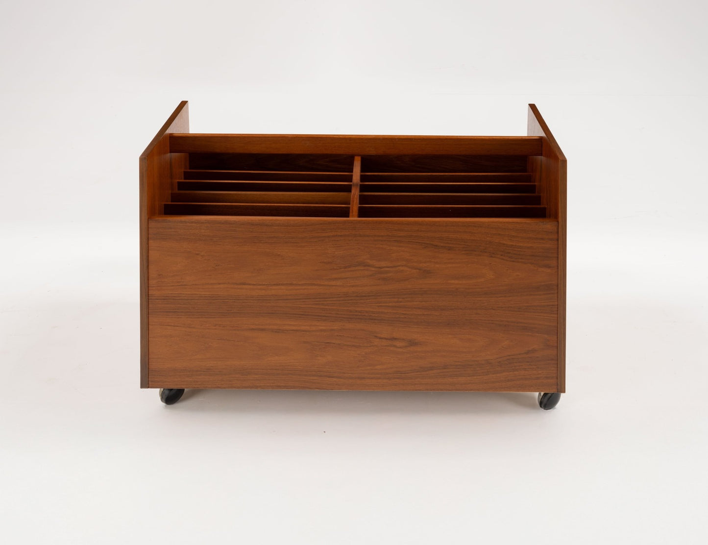 Mid-century modern Rolf Hesland teak record caddy with internal dividers, handle, and castors on a white background.