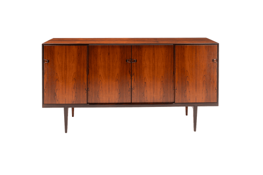 Mid-century modern rosewood credenza with sculpted handles and tapered legs on white background