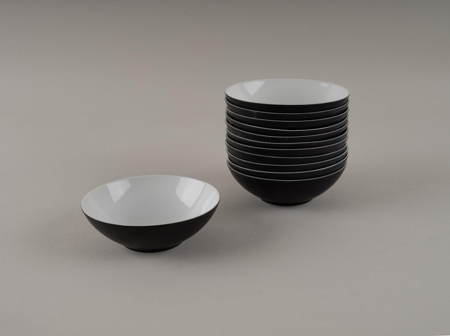 Set of eleven Rosenthal "Charcoal" bowls designed by Raymond Loewy in eggshell black and white glaze from the 1950s.