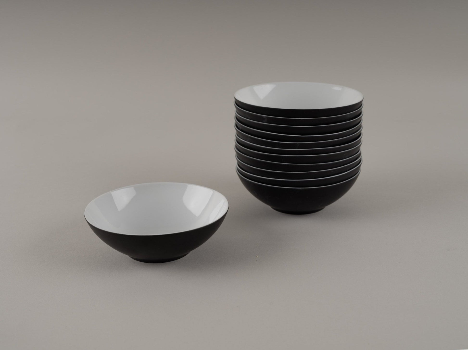 Set of eleven Rosenthal "Charcoal" bowls designed by Raymond Loewy in eggshell black and white glaze from the 1950s.