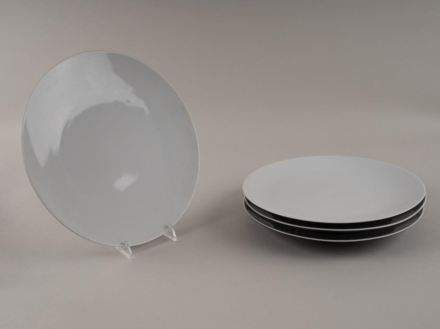 Set of four Rosenthal "Charcoal" eggshell black china dinner plates designed by Raymond Loewy, 1955-1965.