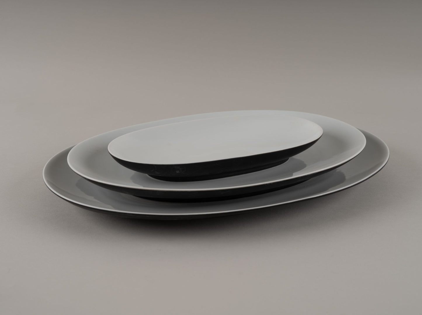 Set of three Rosenthal "Charcoal" china plates designed by Raymond Loewy, eggshell black with glossy finish from 1950s-60s.