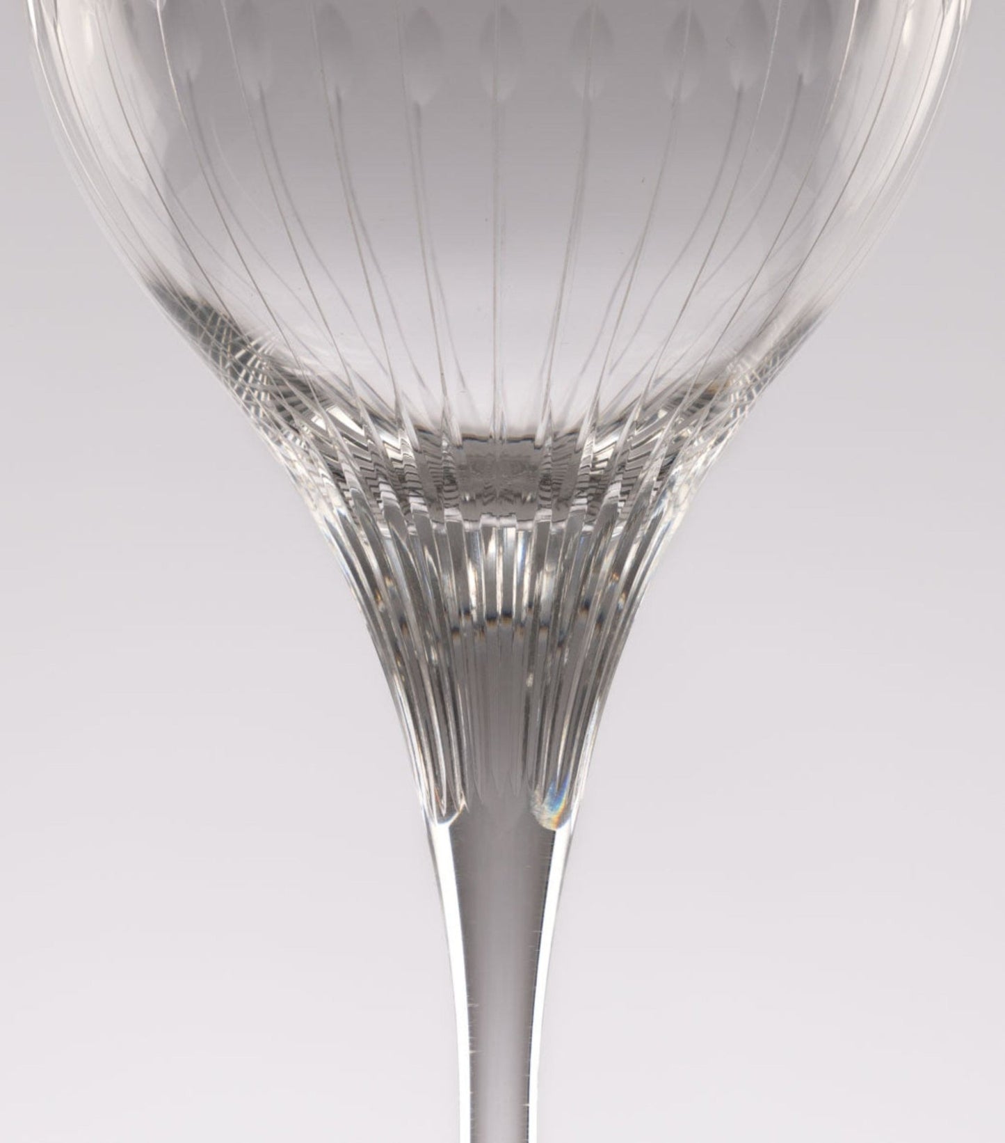 Close-up of Rosenthal Lotus Cut crystal stemware from 1960s featuring faceted lotus petal pattern on clear glass