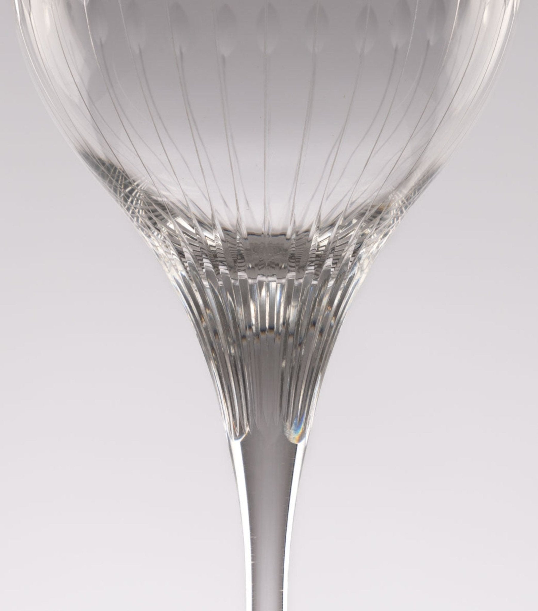 Close-up of Rosenthal Lotus Cut crystal stemware from 1960s featuring faceted lotus petal pattern on clear glass