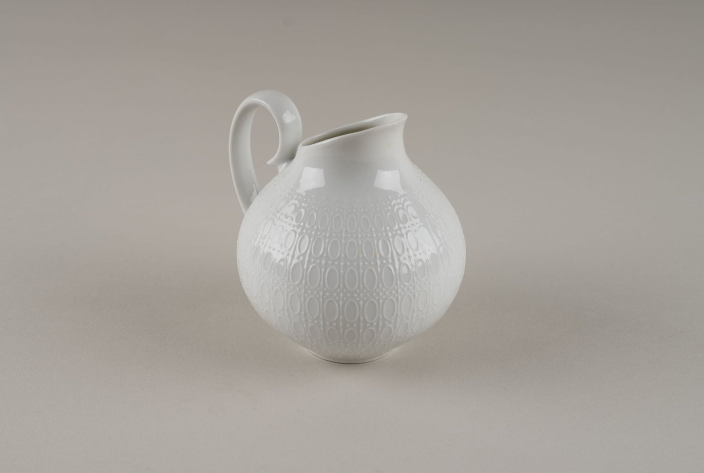 Rosenthal "Romance" white porcelain pitcher with embossed oval and dot pattern by Bjorn Wiinblad