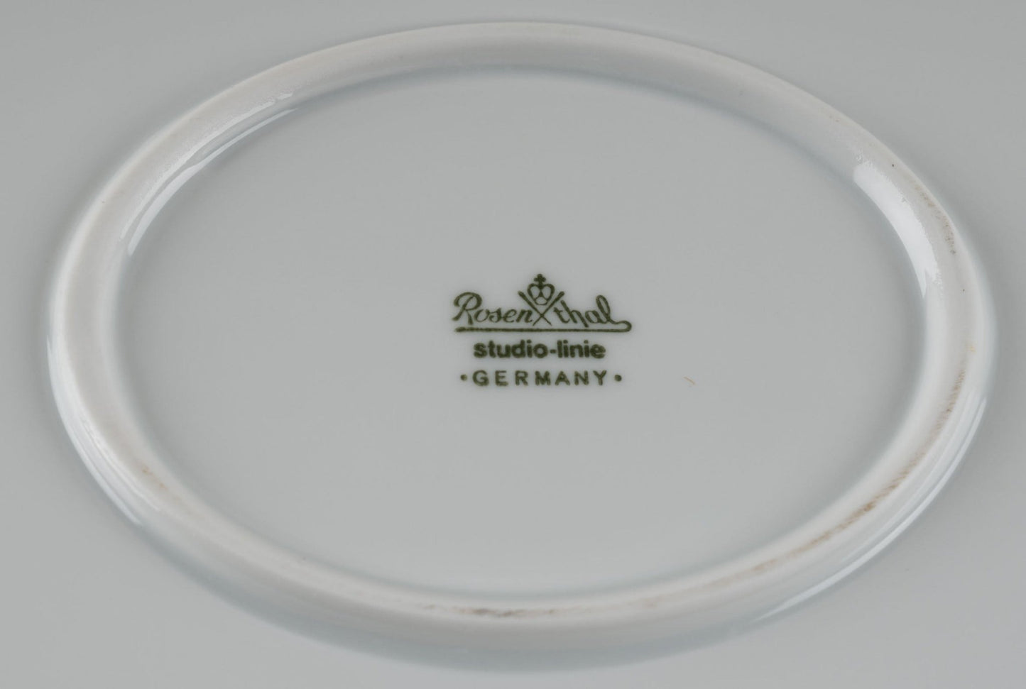 Bottom view of Rosenthal Studio-Line porcelain plate with green stamp and Germany mark on white china surface