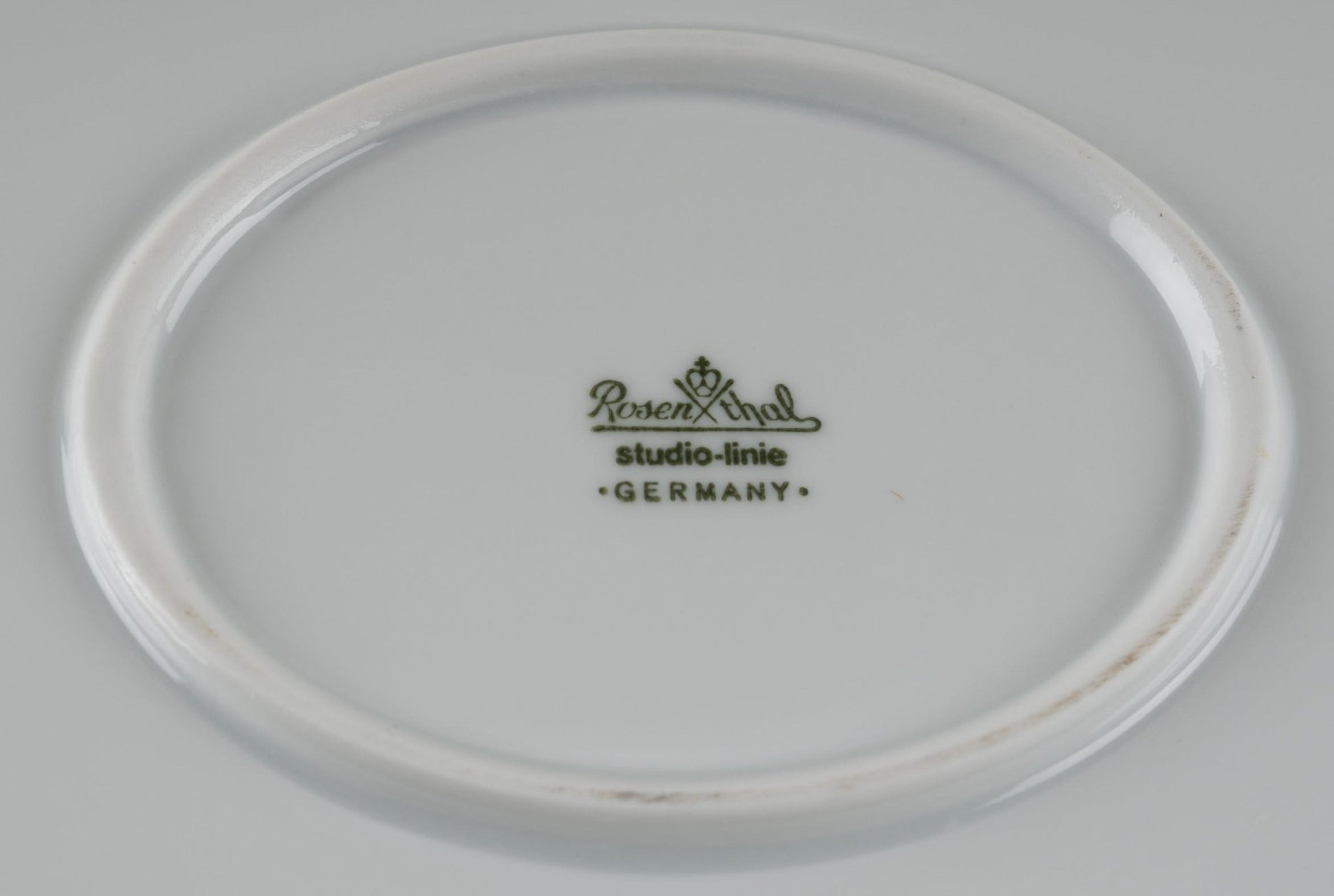 Bottom view of Rosenthal Studio-Line porcelain plate with green stamp and Germany mark on white china surface