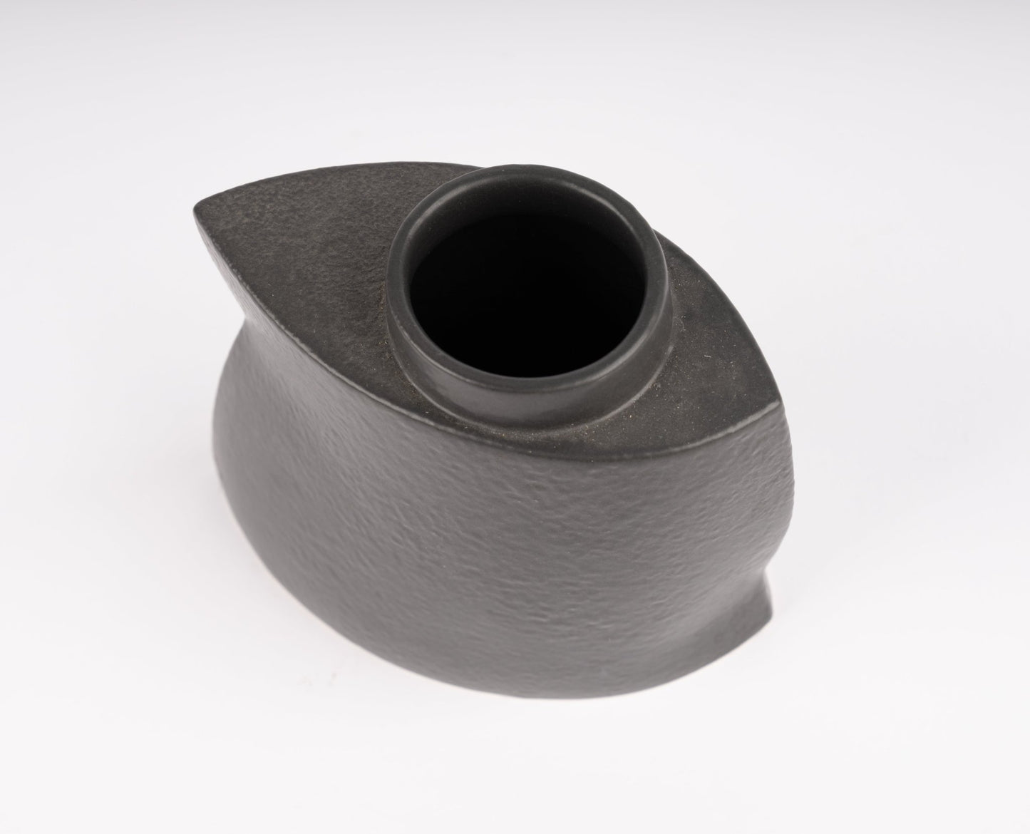 Top view of sculptural black stoneware vase with asymmetrical faceted silhouette and matte charcoal finish \